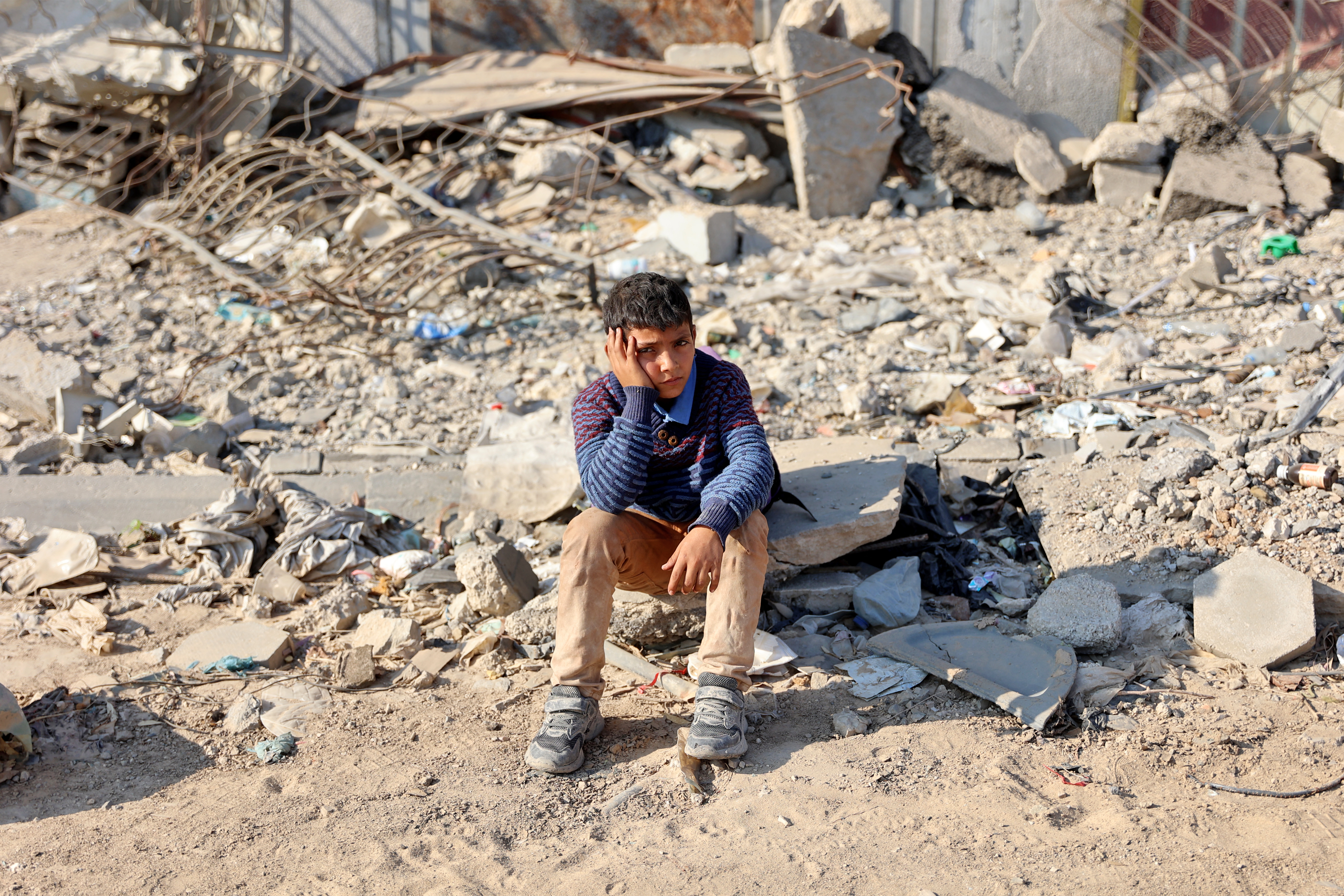 A boy rests as displaced Palestinians flee Beit Lahia in the northern Gaza Strip, through the main Salah al-Din road on the outskirts of Gaza City, on November 5, 2024, amid the ongoing war between Israel and Hamas. Photo / AFP