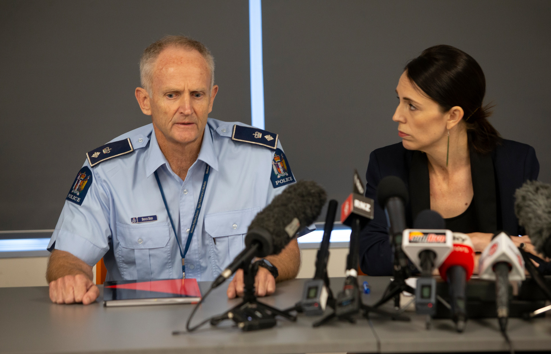Police spokesman Bruce Bird and Prime Minister Jacinda Ardern speak to media after the eruption at Whaakari/White Island. Photo / Alan Gibson