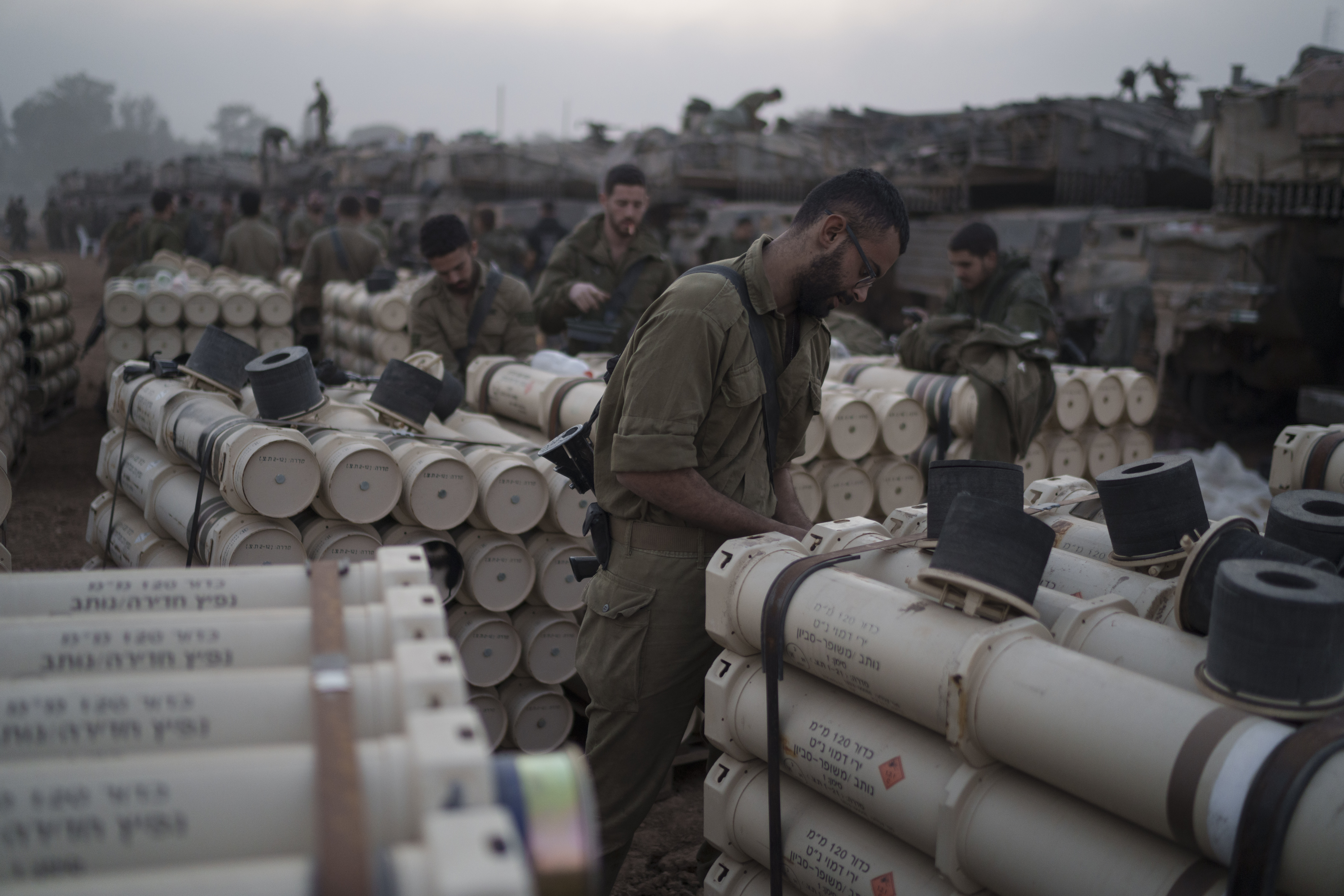 Israeli soldiers from the artillery unit store tank shells in a staging area at the Israeli-Gaza border in southern Israel, Monday, Jan. 1, 2024. (AP Photo/Leo Correa)