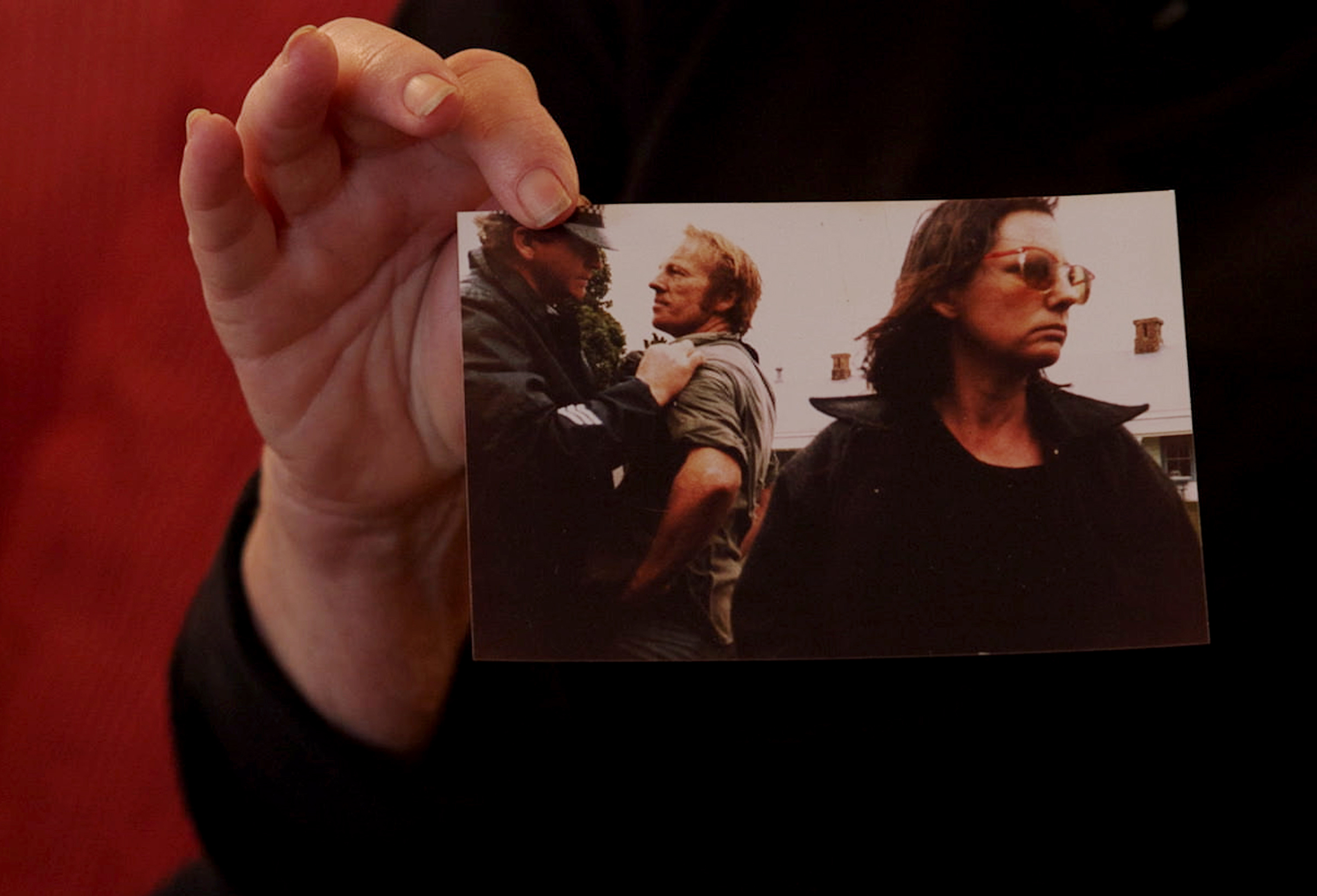 Kate Donoghue holds up a photo of her taken around 1988 after she blocked in a drilling rig. Photo / Mike Scott