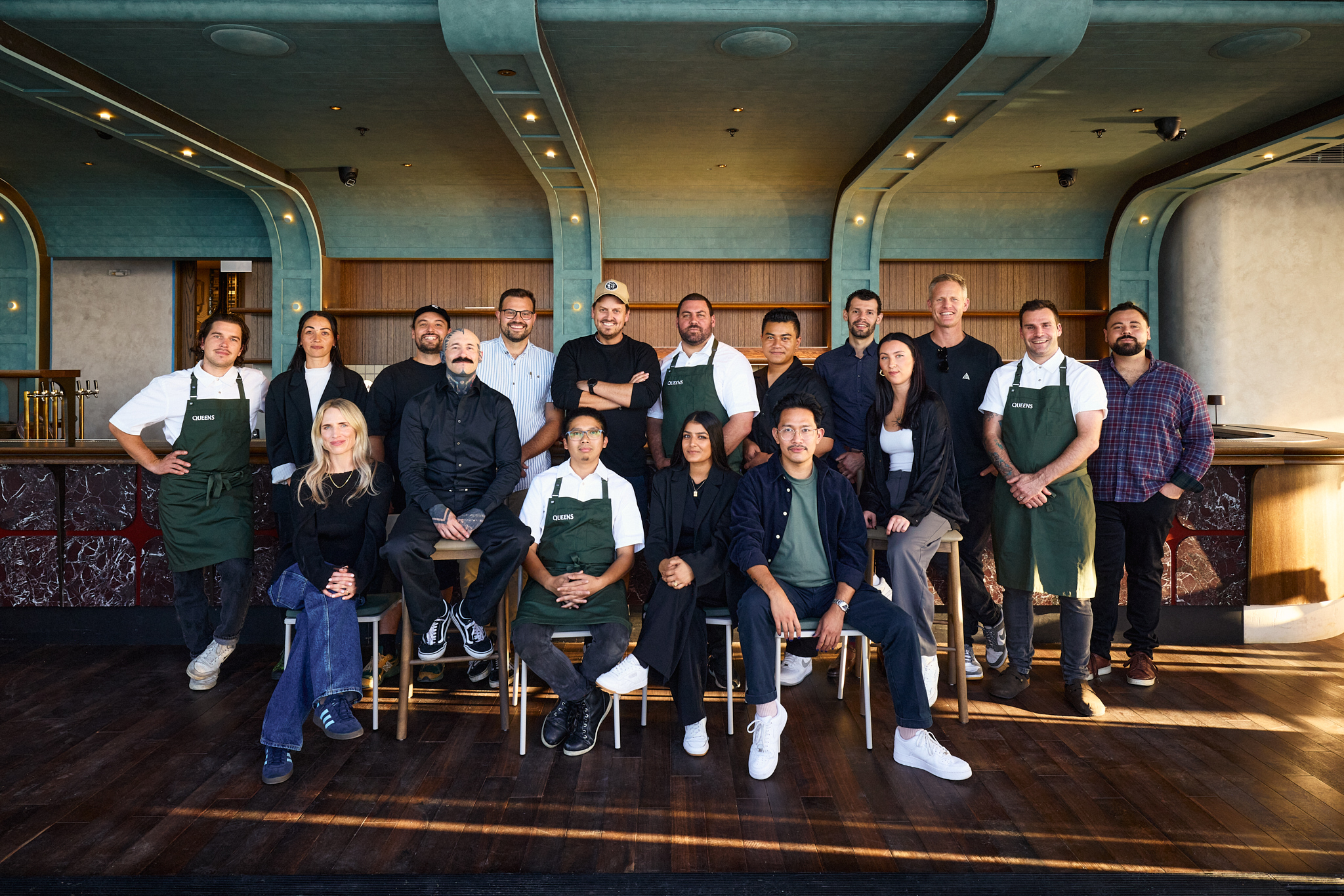 The Queens’ team, back row left to right: Antoine Rouge, Tahlia Moses-Pene, Kristian Lloydd, John Robertson, Callum O'Brien, Maia Atvars, Filo Aiono, Maxence Dralou, Andrew Roborgh, Jamie Johnston, Reuben Ruscoe. Front row: Eloise Shanahan, Javier Korpos (high stool) , Drexler Lumangtad, Sarina Manak, Mykhel Latosa, Morgan Bartholomew (high stool). Photo / Jake Dennis