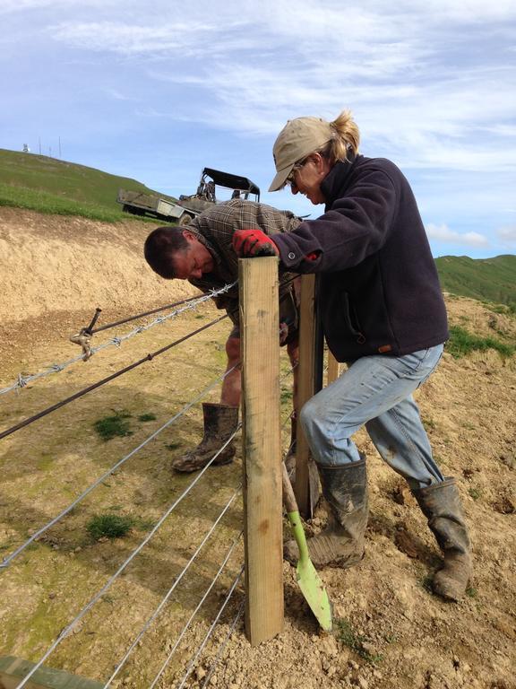 Roger and Barb Barton work on fencing at their boundary. Photo / Rachel Thomas