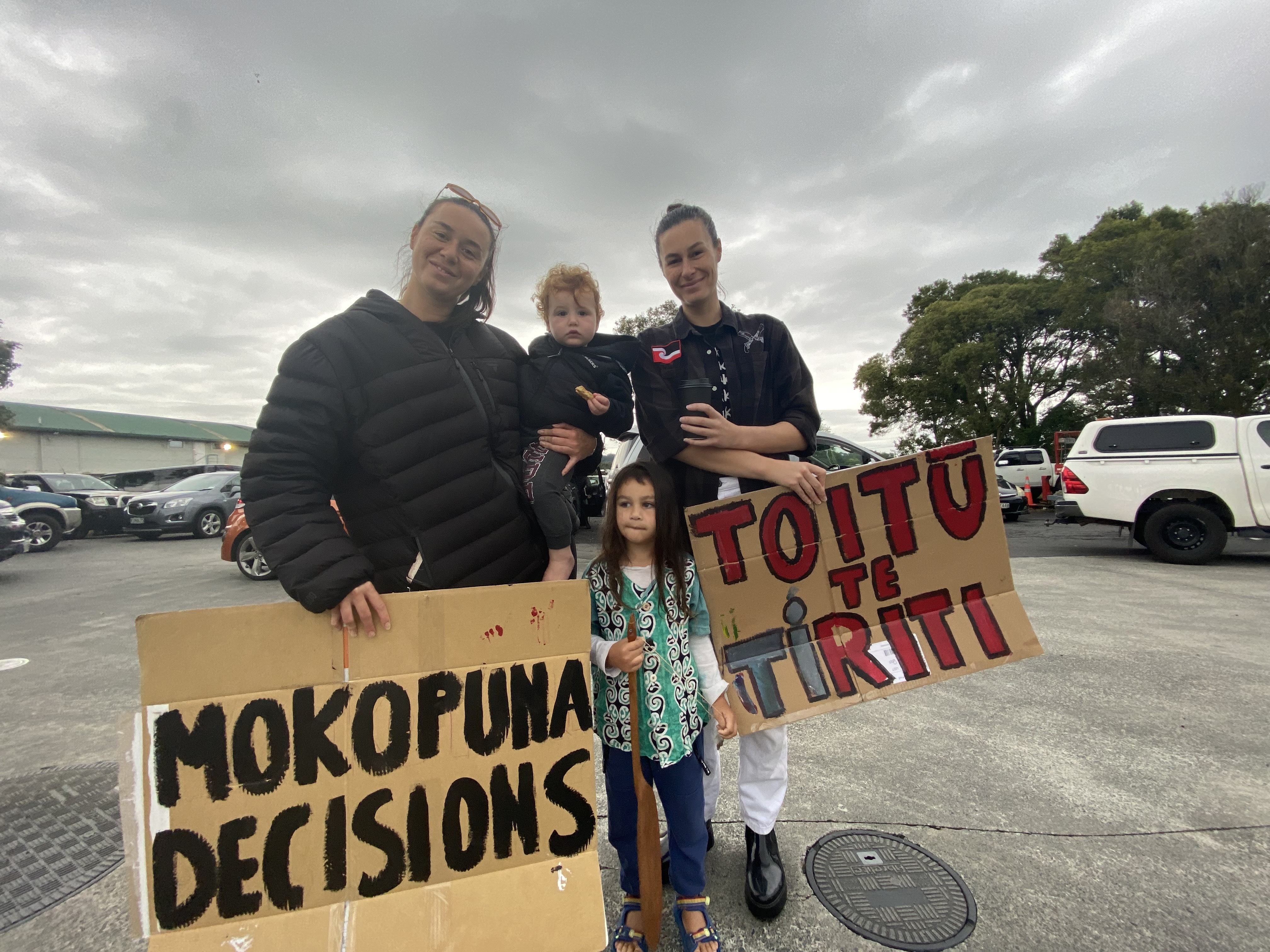 Clockwise from left: Te Huia Taylor holding Rehua Malcolm, Kahurangi Malcolm and Kaiwhare Malcolm, protesting at the BP at Bombay.