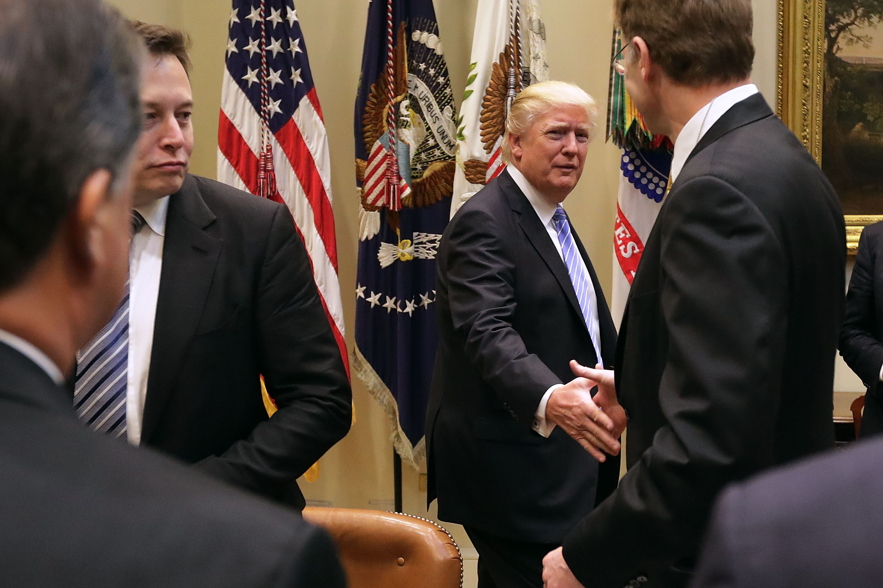 Elon Musk, left, and President Donald Trump in 2017 at the White House during a breakfast for business leaders. Musk has transformed himself from an idealistic supporter of Democrats into a fierce ally of Trump. Photo / Getty Images