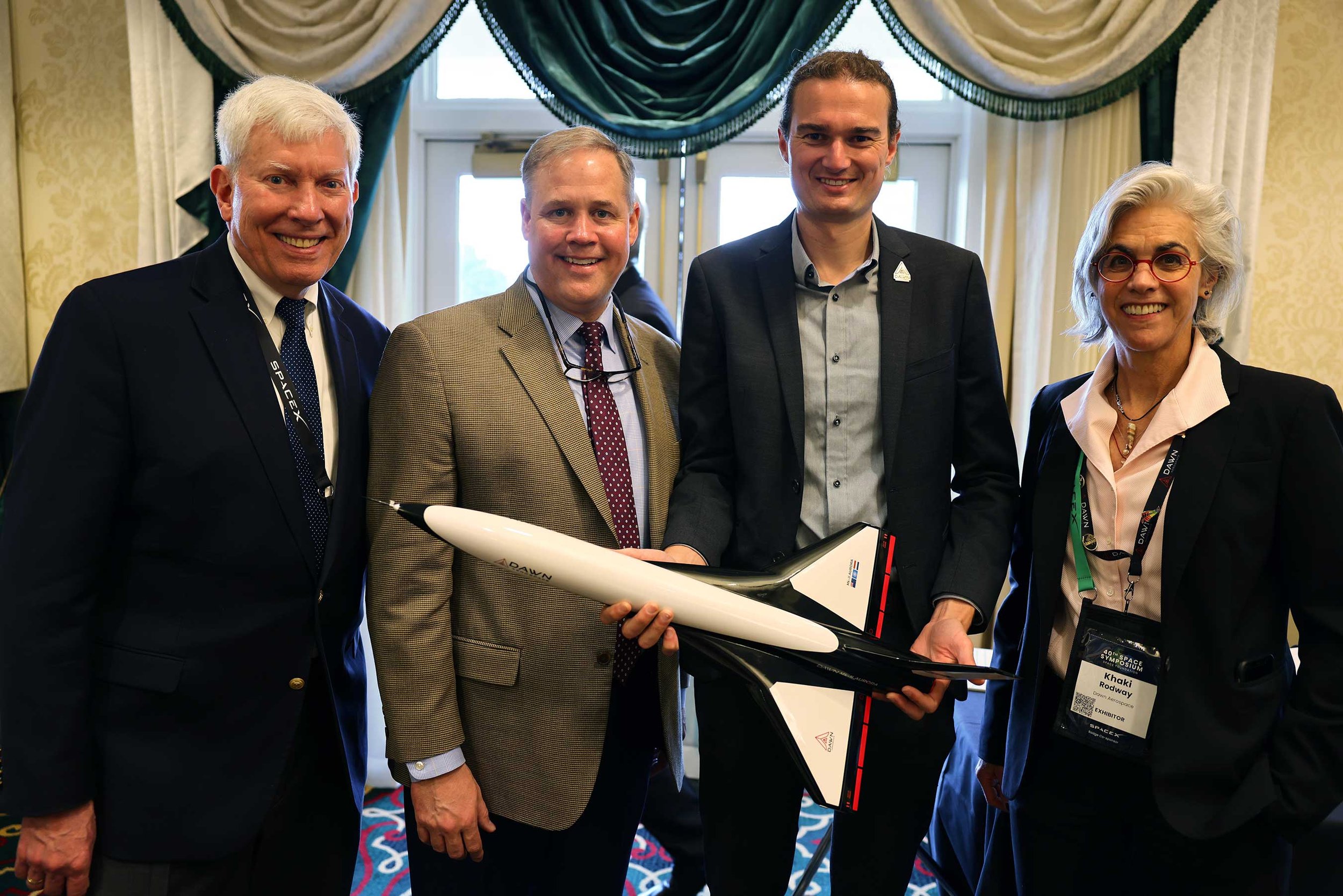 From left: Dr George Nield (chairman, Global Spaceport Alliance), Jim Bridenstine (managing partner of the Artemis Group and former NASA Administrator), Stefan Powell (CEO, Dawn Aerospace, holding a scale model of the Aurora), and Khaki Rodway (spaceplane sales & operations director, USA, Dawn Aerospace) at the Space Symposium 2025 in Colorado Springs. Photo / Supplied