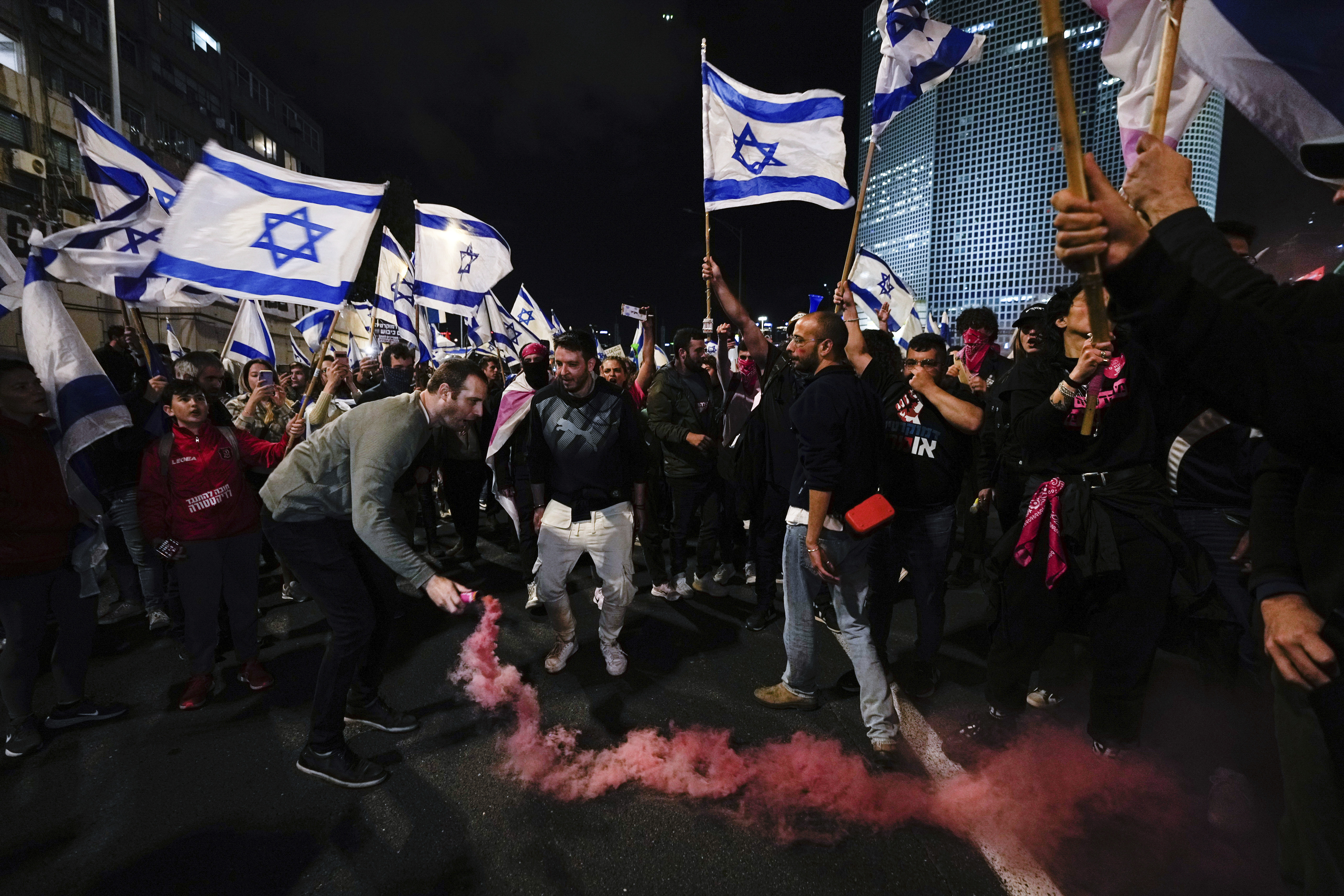 Demonstrators block a highway during a protest against plans by the government to overhaul Israel's judicial system, in Tel Aviv. Photo / AP