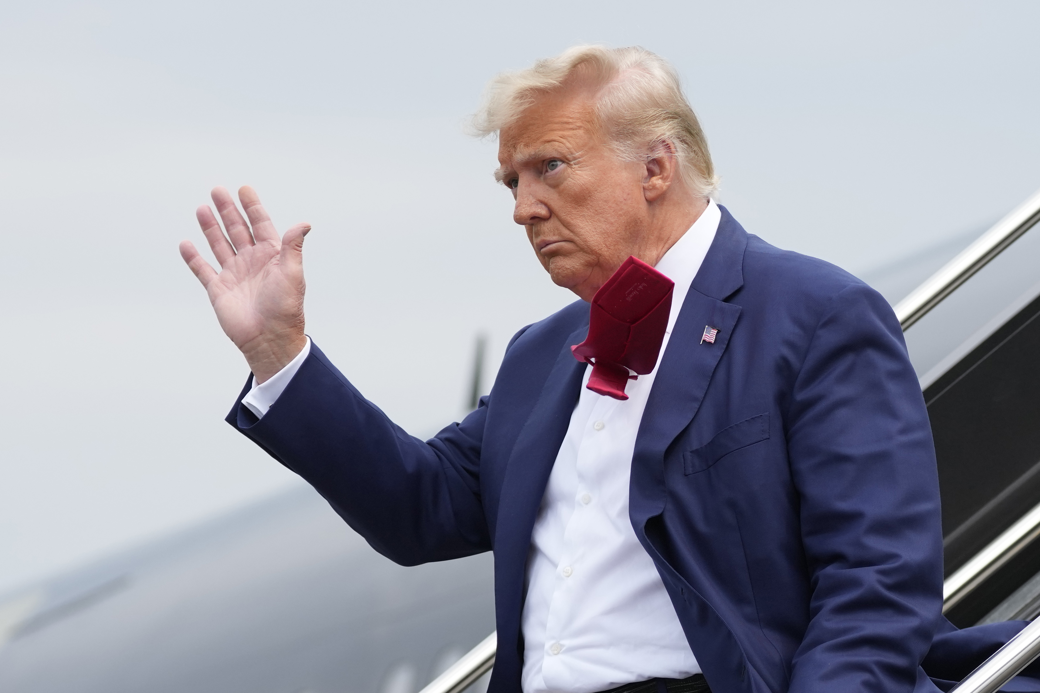 Former President Donald Trump waves as he steps off his plane at Ronald Reagan Washington National Airport, as he heads to Washington to face a judge on federal conspiracy charges to subvert the 2020 election. Photo / Alex Brandon, AP