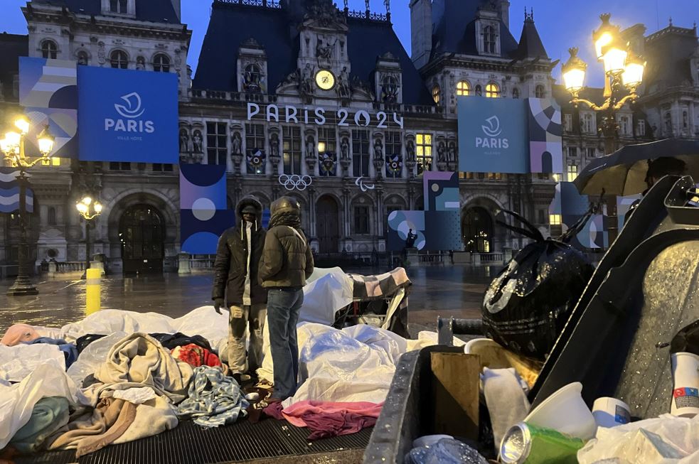 Migrants stand in front of the Paris City Hall earlier this year. French police had removed about 50 migrants, including families with young children, from the Paris City Hall plaza in the lead-up to the Olympic Games, which start on July 26. Photo / Nicolas Garriga, AP
