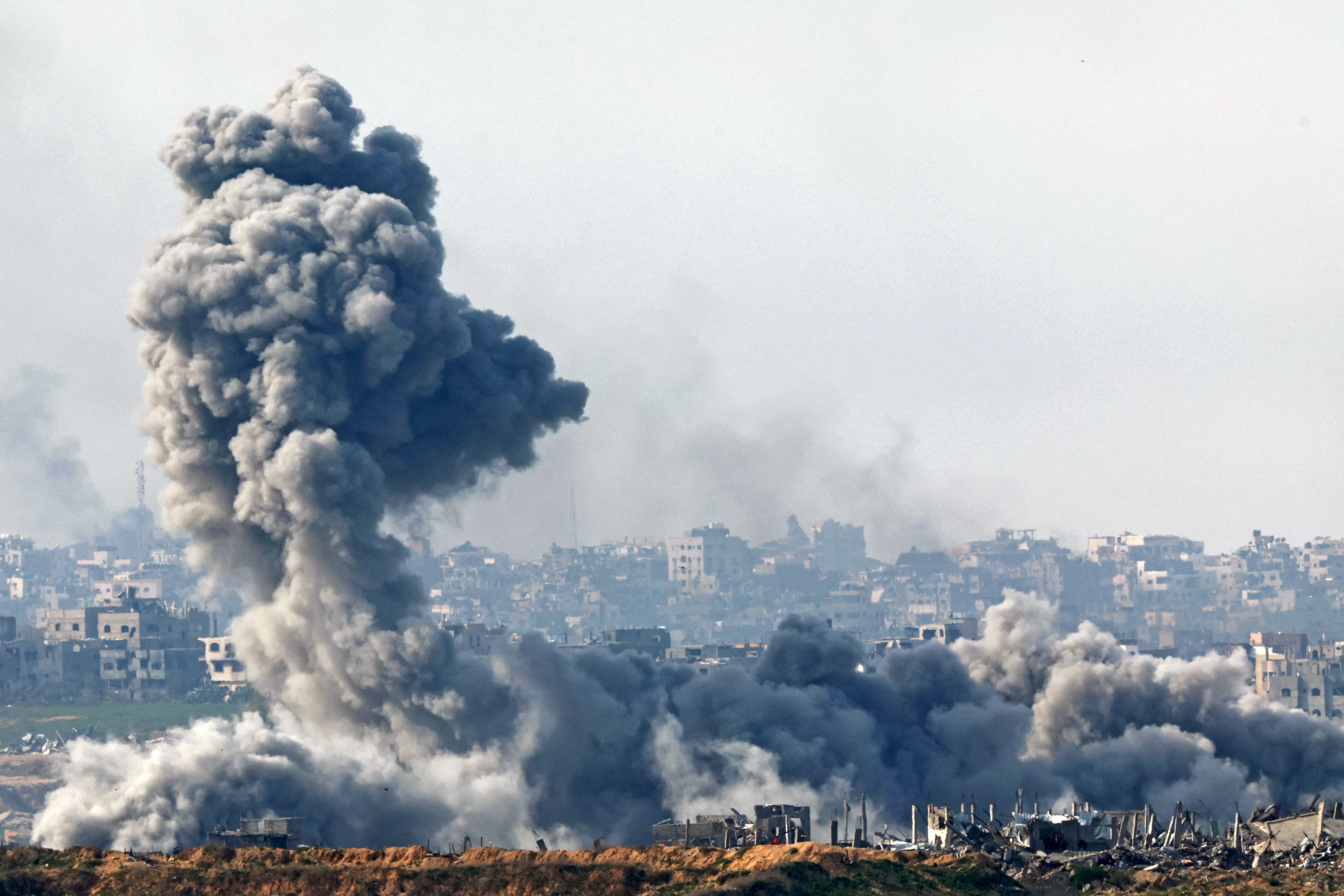Smoke plumes rise from explosions above destroyed buildings in the northern Gaza Strip earlier this week, amid the ongoing war between Israel and Hamas. Photo / AFP