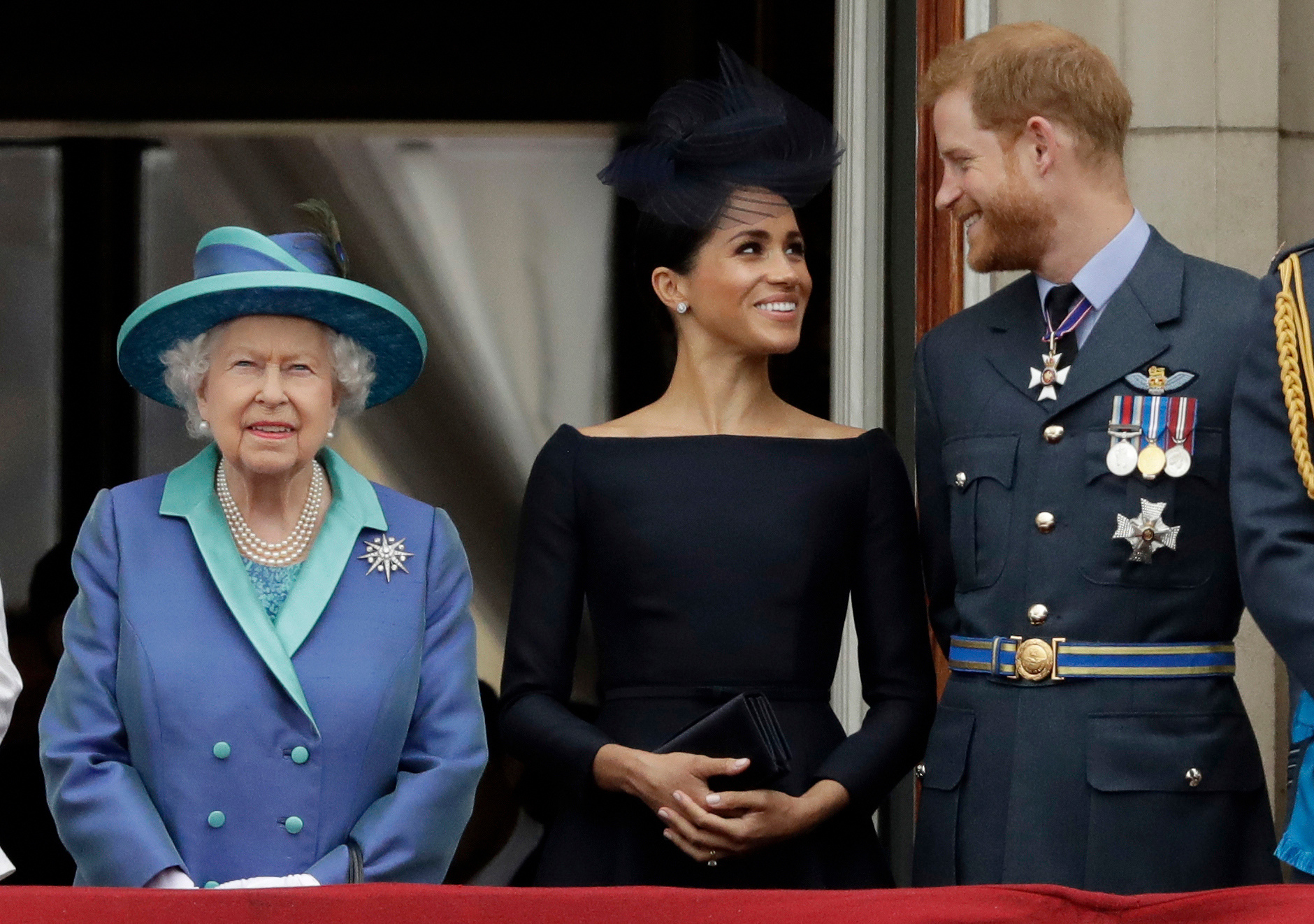 Queen Elizabeth II with Meghan the Duchess of Sussex and Prince Harry watch a flypast of Royal Air Force aircraft pass over Buckingham Palace. Photo / AP