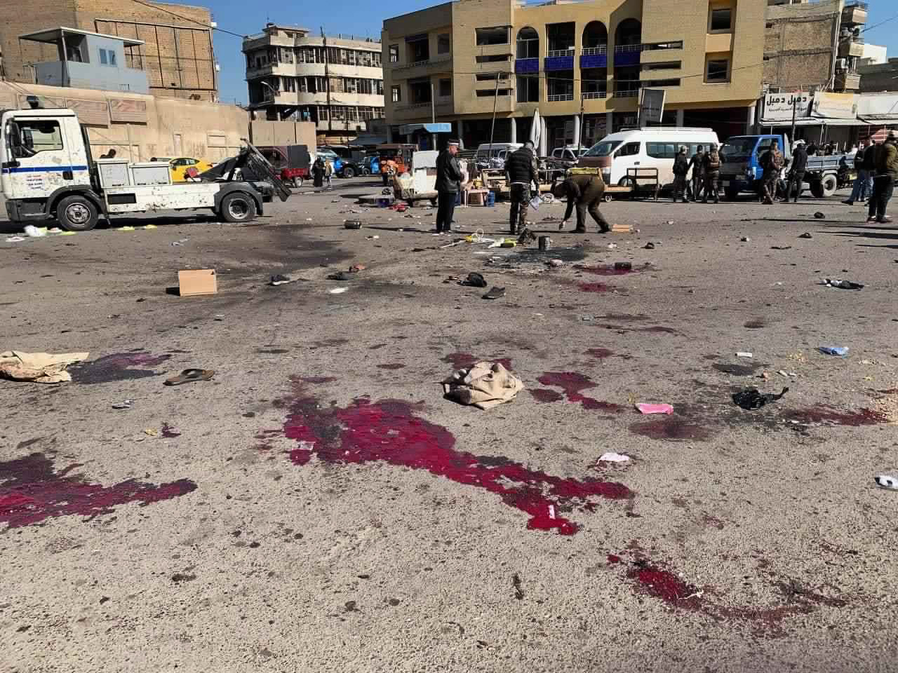 Security forces work at the site of a deadly bomb attack in a market selling used clothes, Iraq. Photo / AP