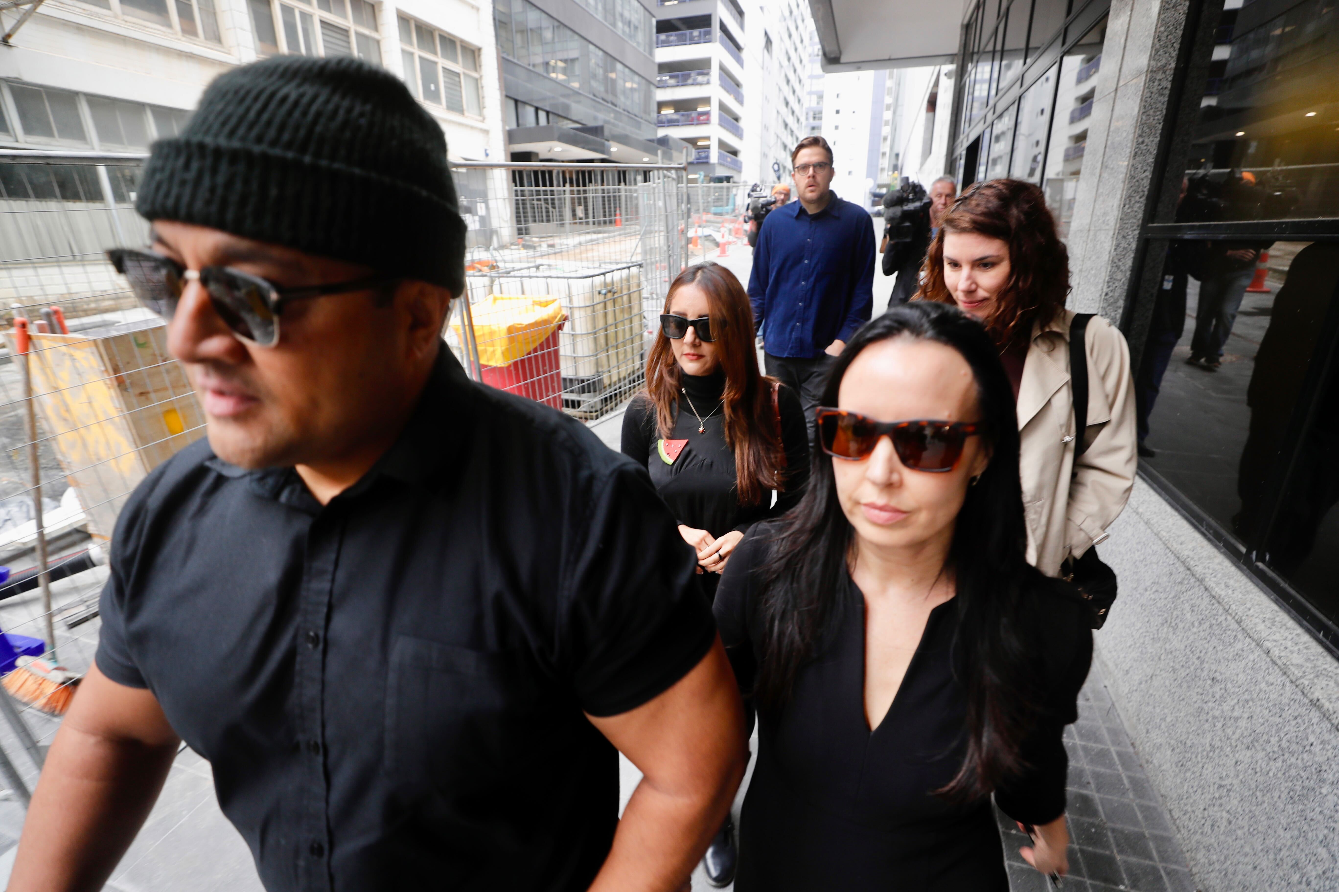 Former Green MP Golriz Ghahraman arrives at Auckland District Court for sentencing, flanked by supporters including her ex-partner Guy Williams. Photo / Dean Purcell