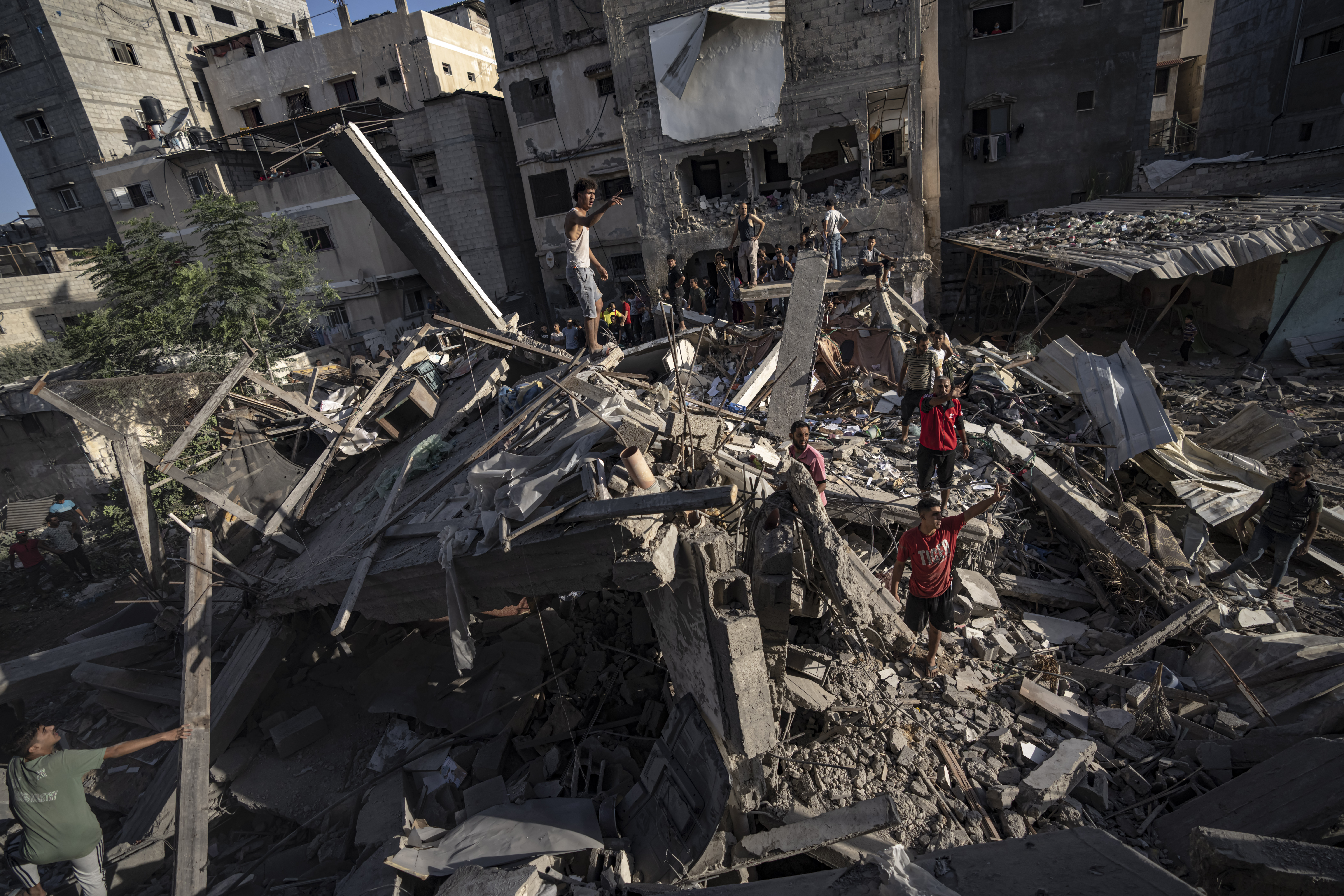 Palestinians look at the destruction after Israeli strikes on the Gaza Strip in Khan Younis. Photo / AP
