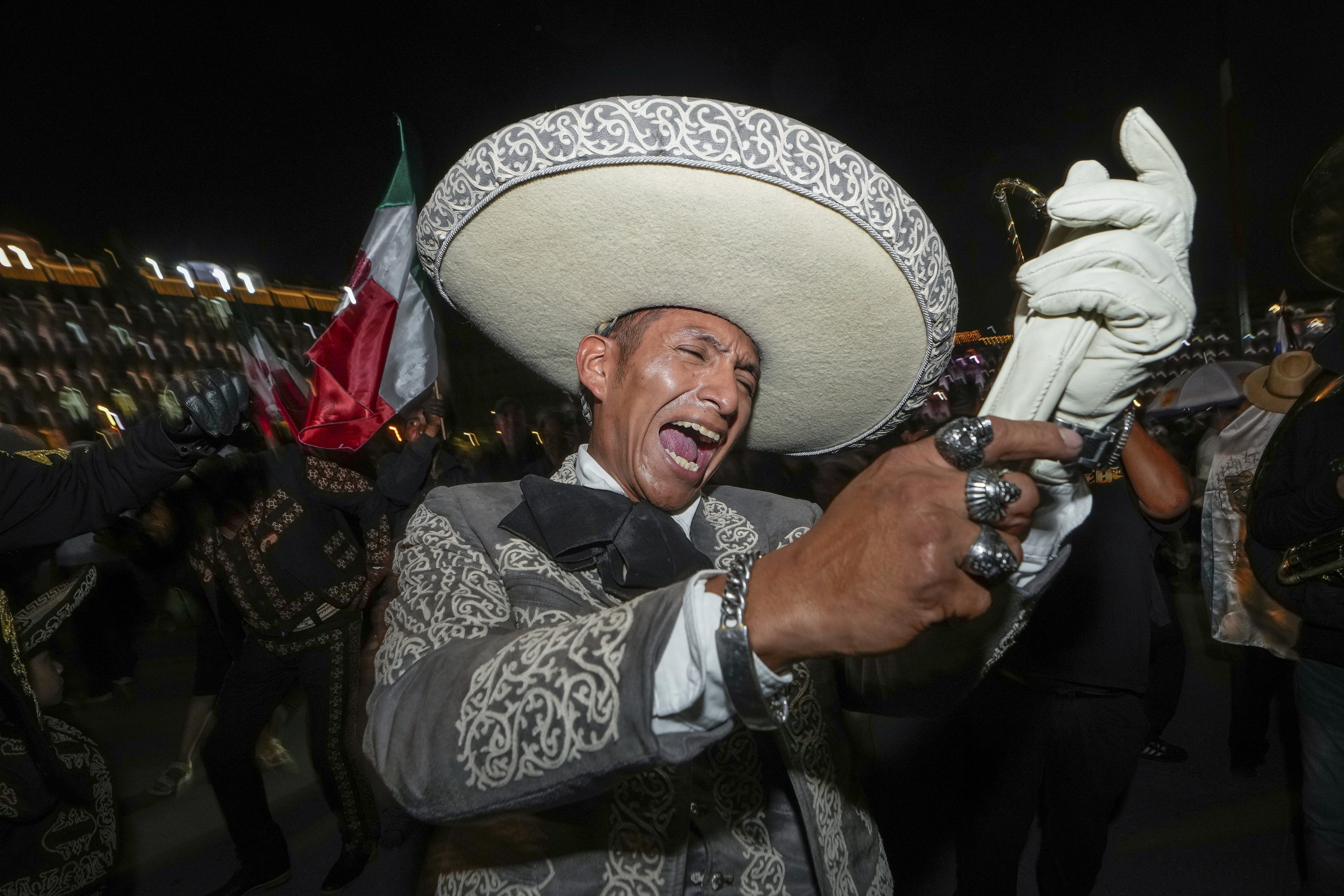 A man dressed in traditional clothing sings after the close of polls during general elections at the Zocalo, Mexico City. Photo / AP