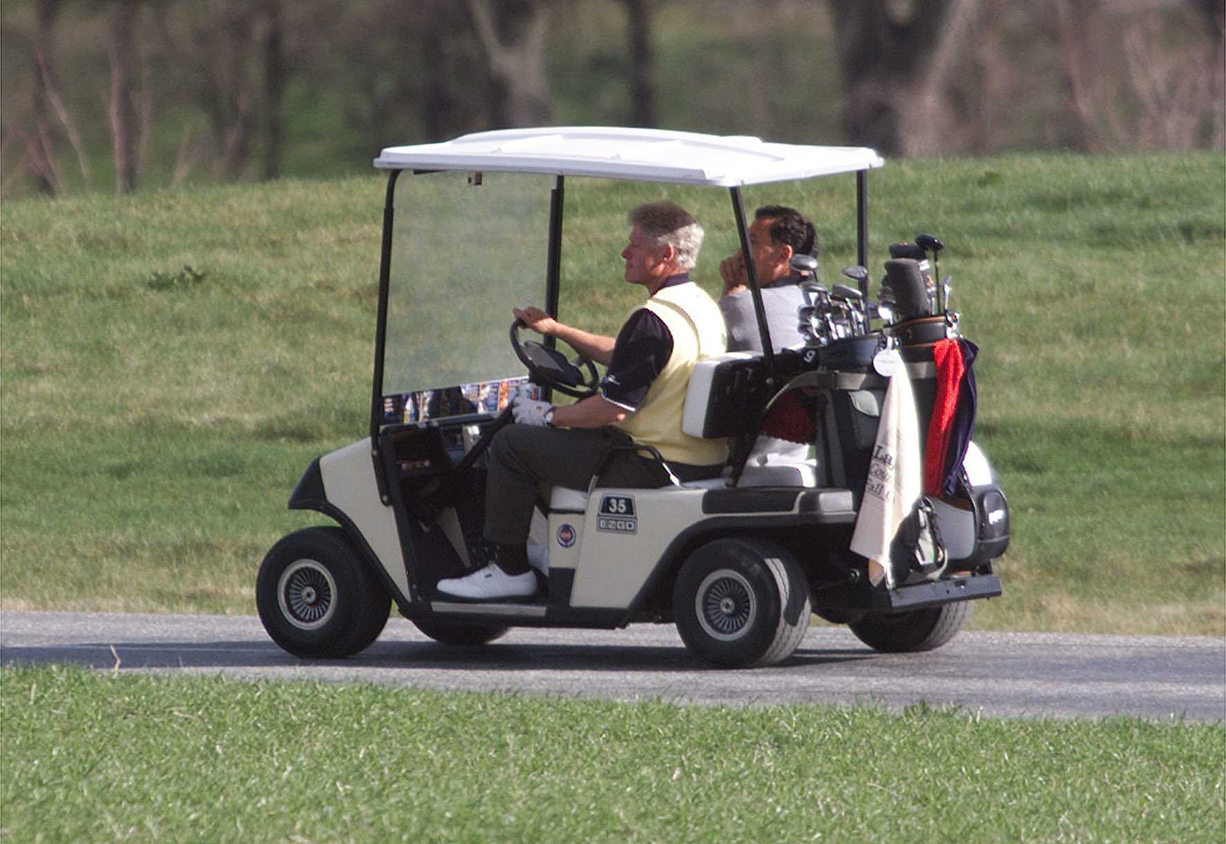 President Bill Clinton drives Burton Shipley, husband of then Prime Minister Jenny Shipley, at Millbrook Resort during a visit in 1999. Photo / Martin Sykes