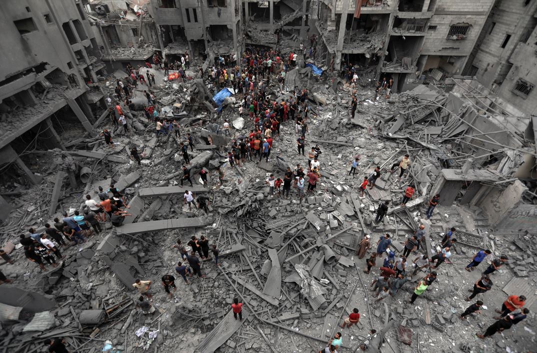 Palestinians inspect the damage of destroyed buildings following Israeli airstrikes on Gaza City, Friday, Oct. 27, 2023. (AP Photo/Abed Khaled)