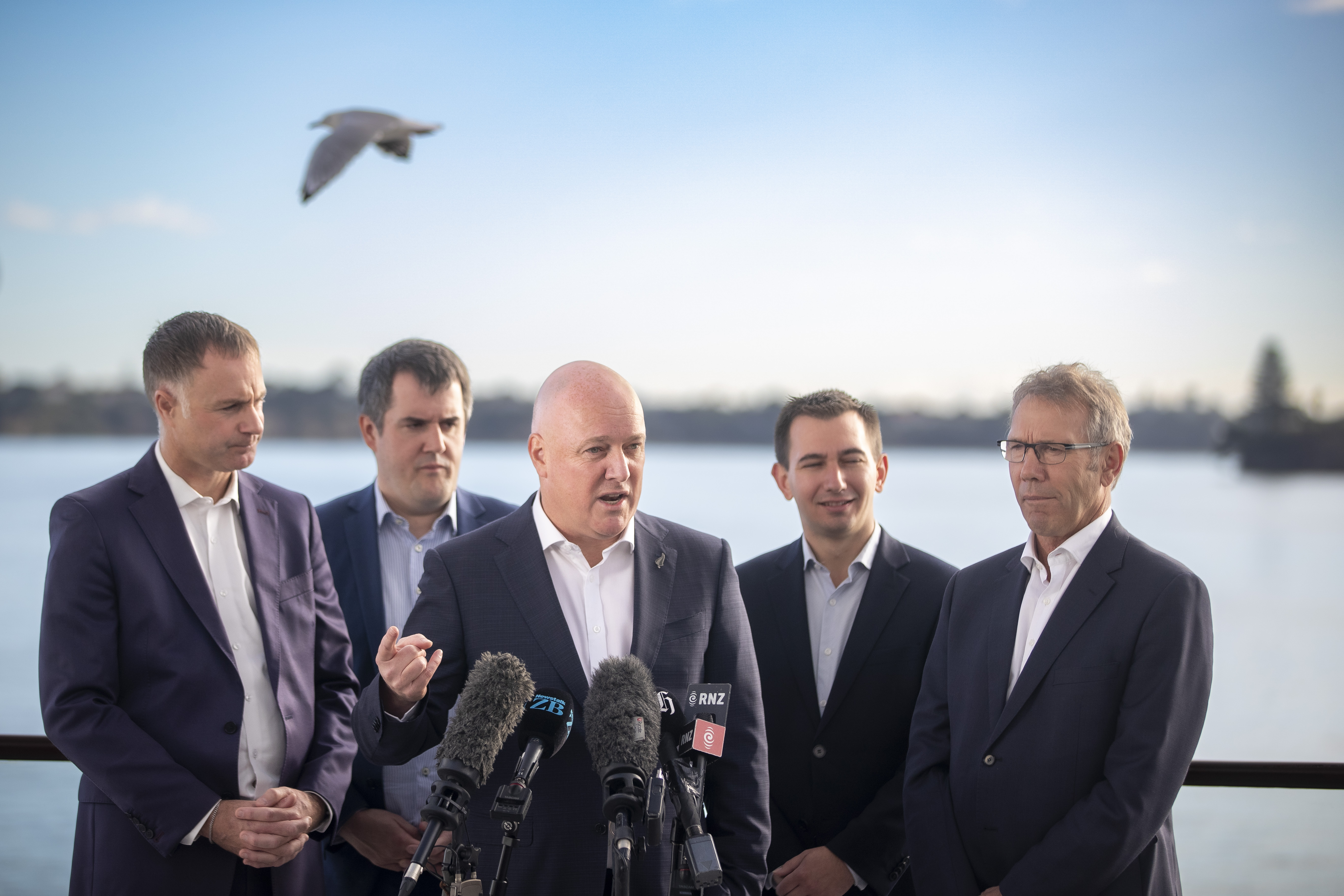 National leader Christopher Luxon (centre) discusses his party's new renewables policy with MPs (from left) Simon Watts, Chris Bishop, Simeon Brown and Stuart Smith. Photo / Michael Craig