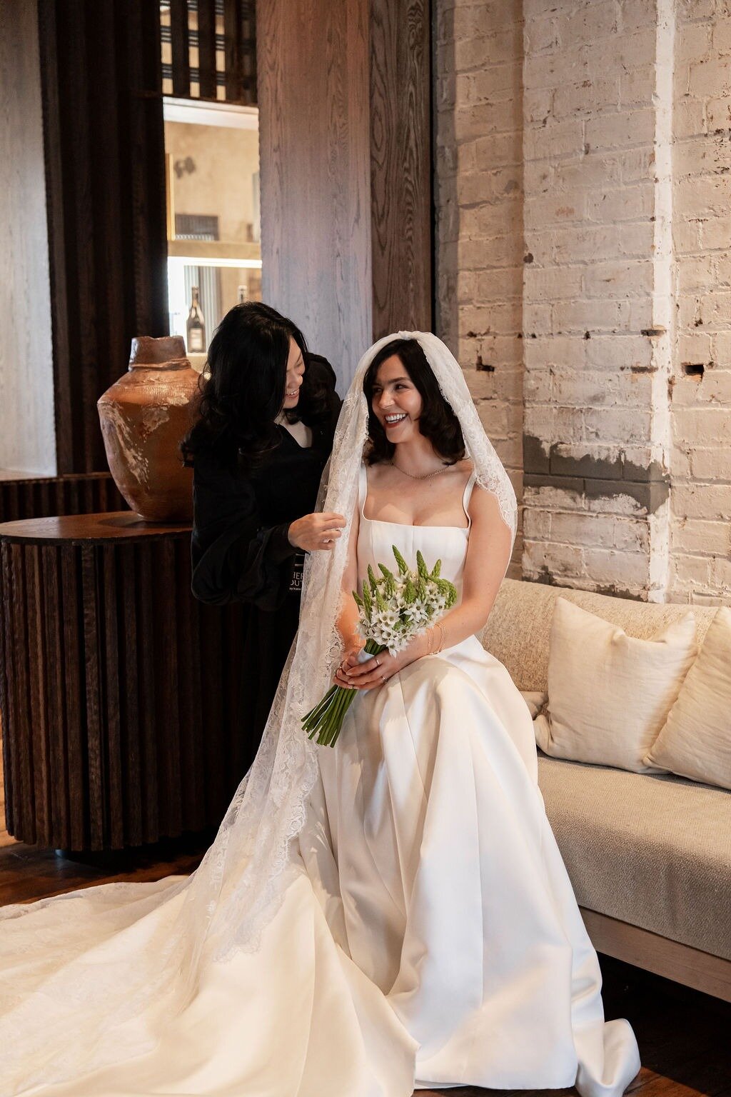 Designer Katie Yeung of Hera Couture with bride Phoebe, who wears her Crescent gown with matching veil. Photo / Supplied