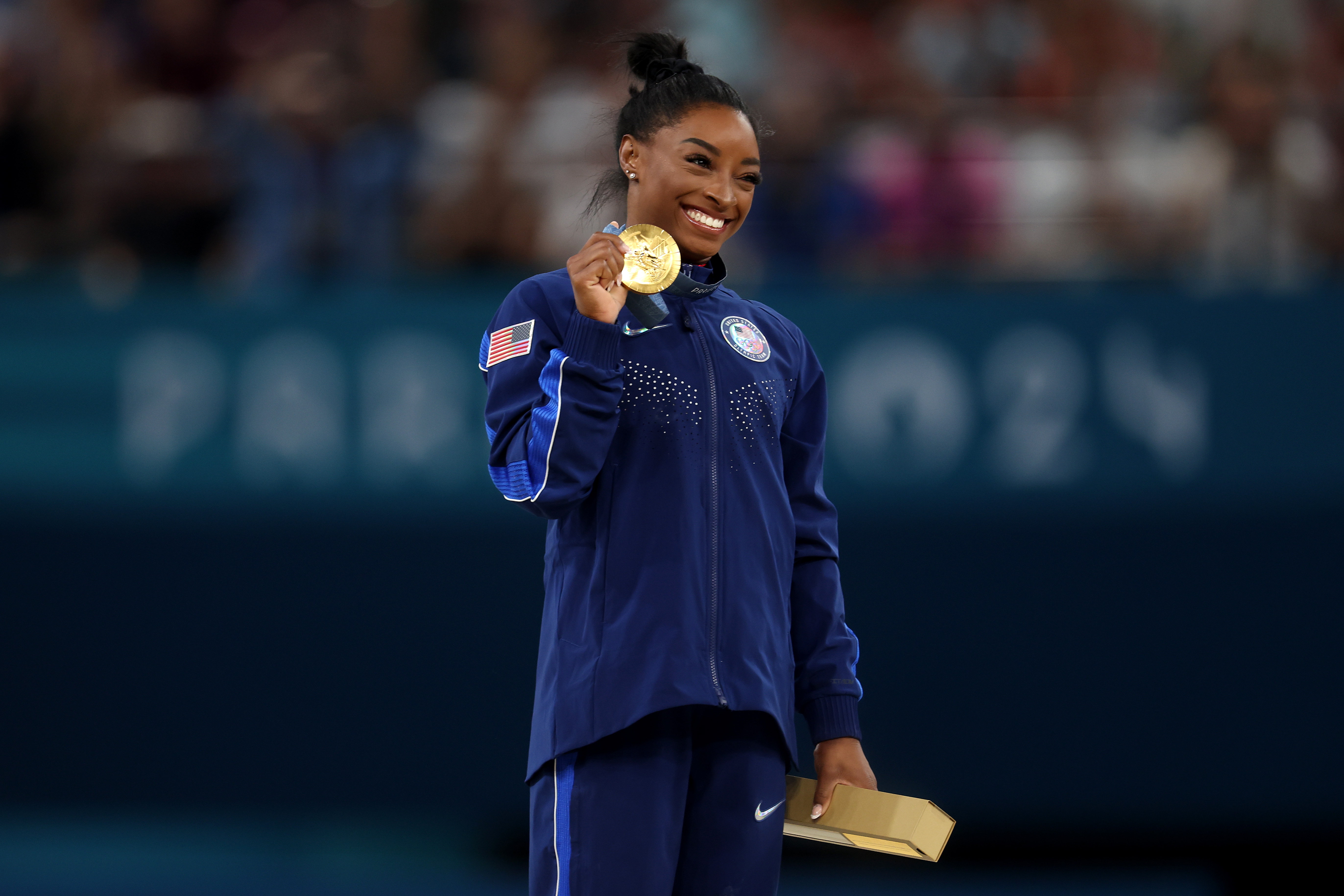 Gold medallist Simone Biles of Team United States celebrates on the podium during the medal ceremony for the Artistic Gymnastics Women's Vault Final on day eight of the Olympic Games Paris 2024 at Bercy Arena on August 3. (Photo by Julian Finney/Getty Images)