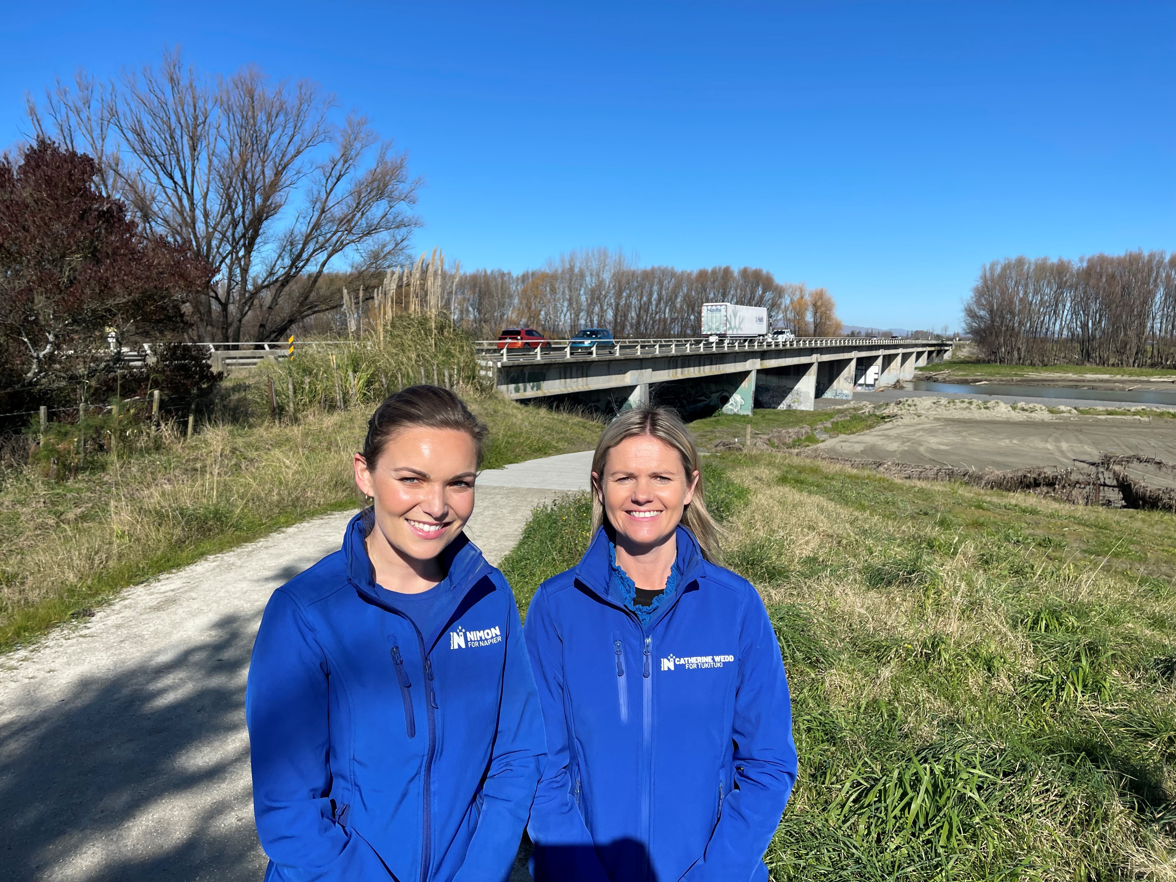 Napier MP Katie Nimon (left) and Tukituki MP Catherine Wedd next to the Hawke's Bay Expressway, which currently has two lanes (one northbound and one southbound).