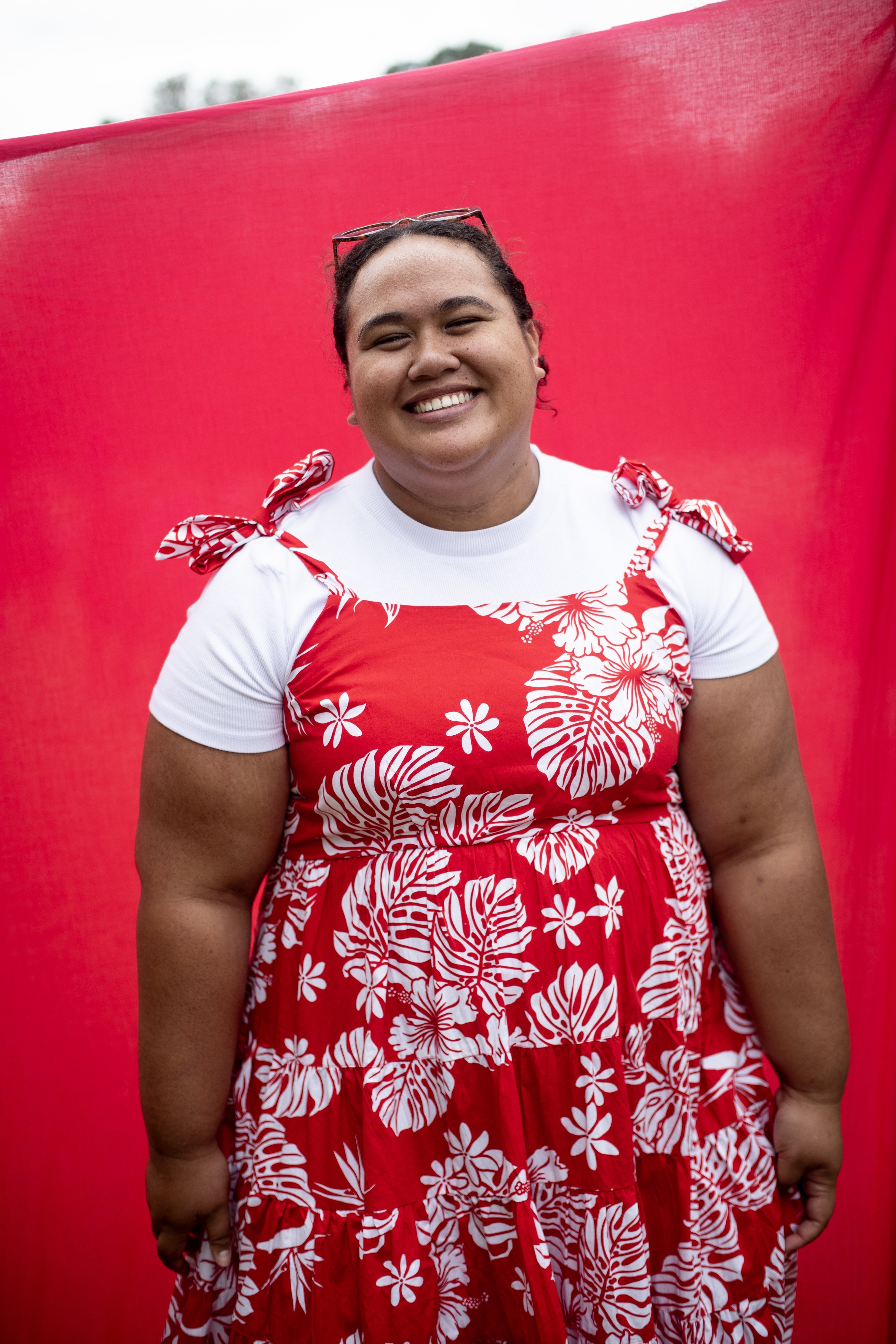 Tiare Kora wears a red and white floral dress, made by her cousin from the brand Moana Liza Essentials, at Pasifika Festival. Photo / Dean Purcell