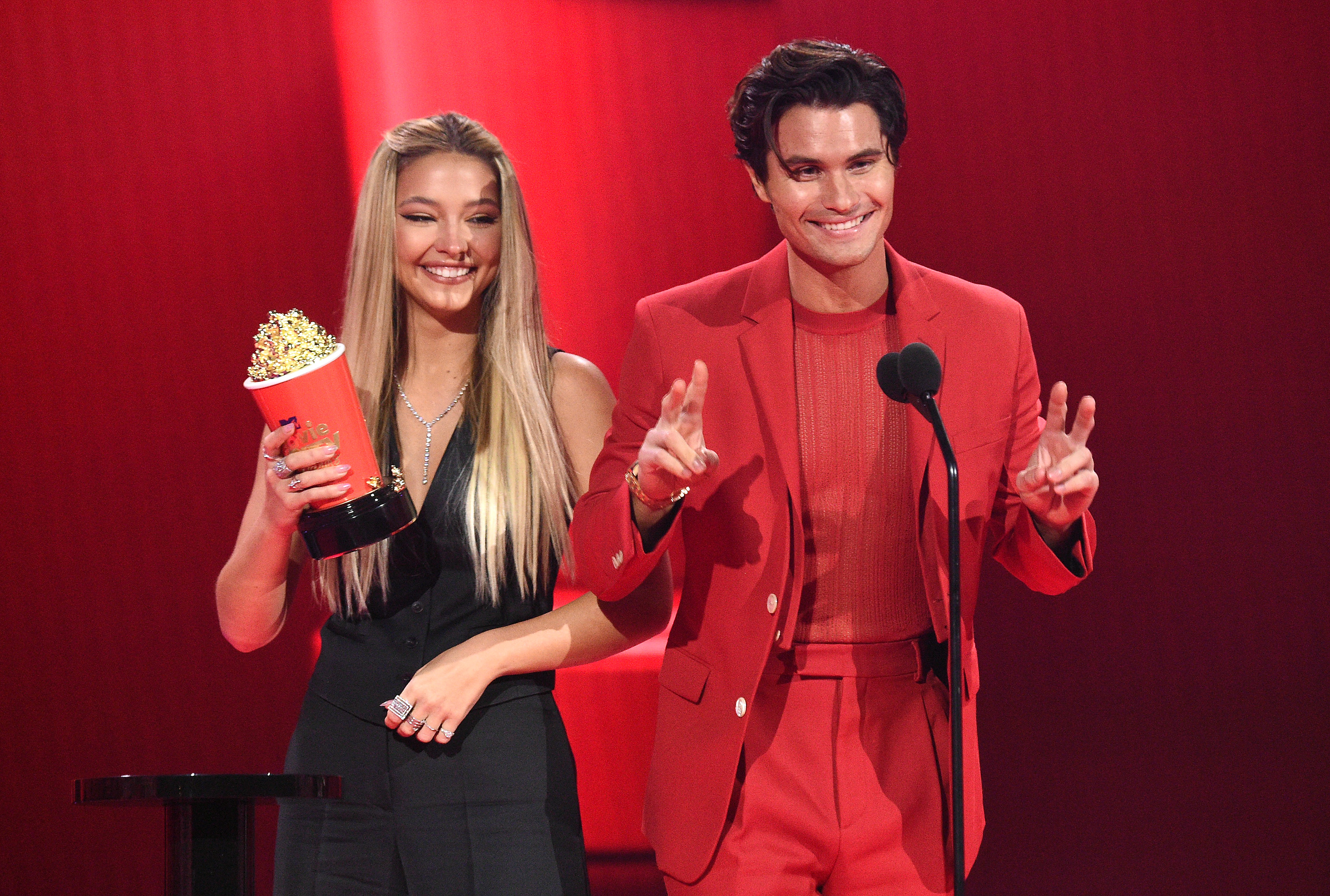 Madelyn Cline and Chase Stokes accept the Best Kiss award for Outer Banks on stage during the 2021 MTV Movie & TV Awards. Photo / Getty Images