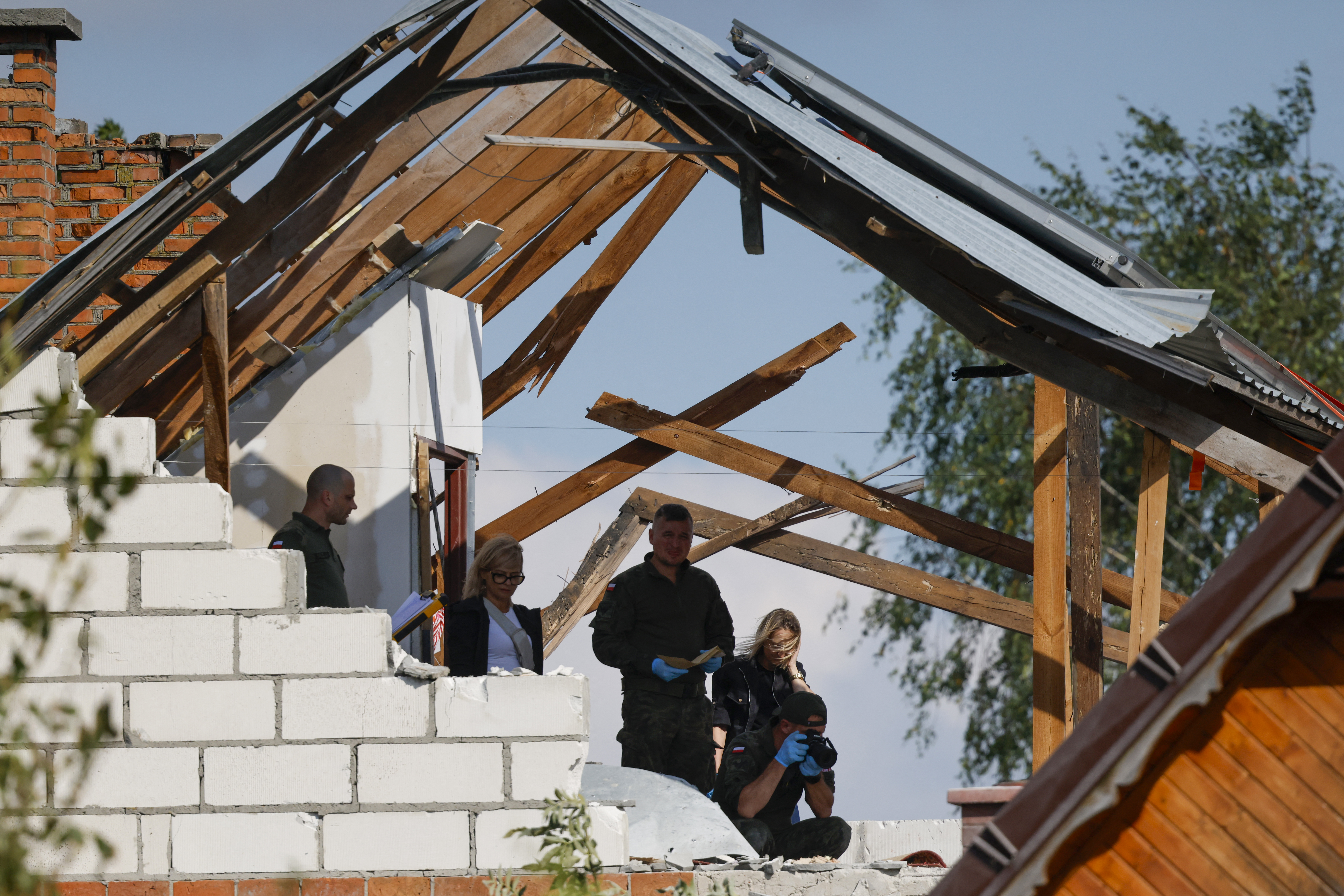 Police and troops inspect damage to a house destroyed by debris from a shot-down Russian drone in the village of Wyryki-Wola, eastern Poland, on Wednesday. Photo / Wojtek Radwanski, AFP