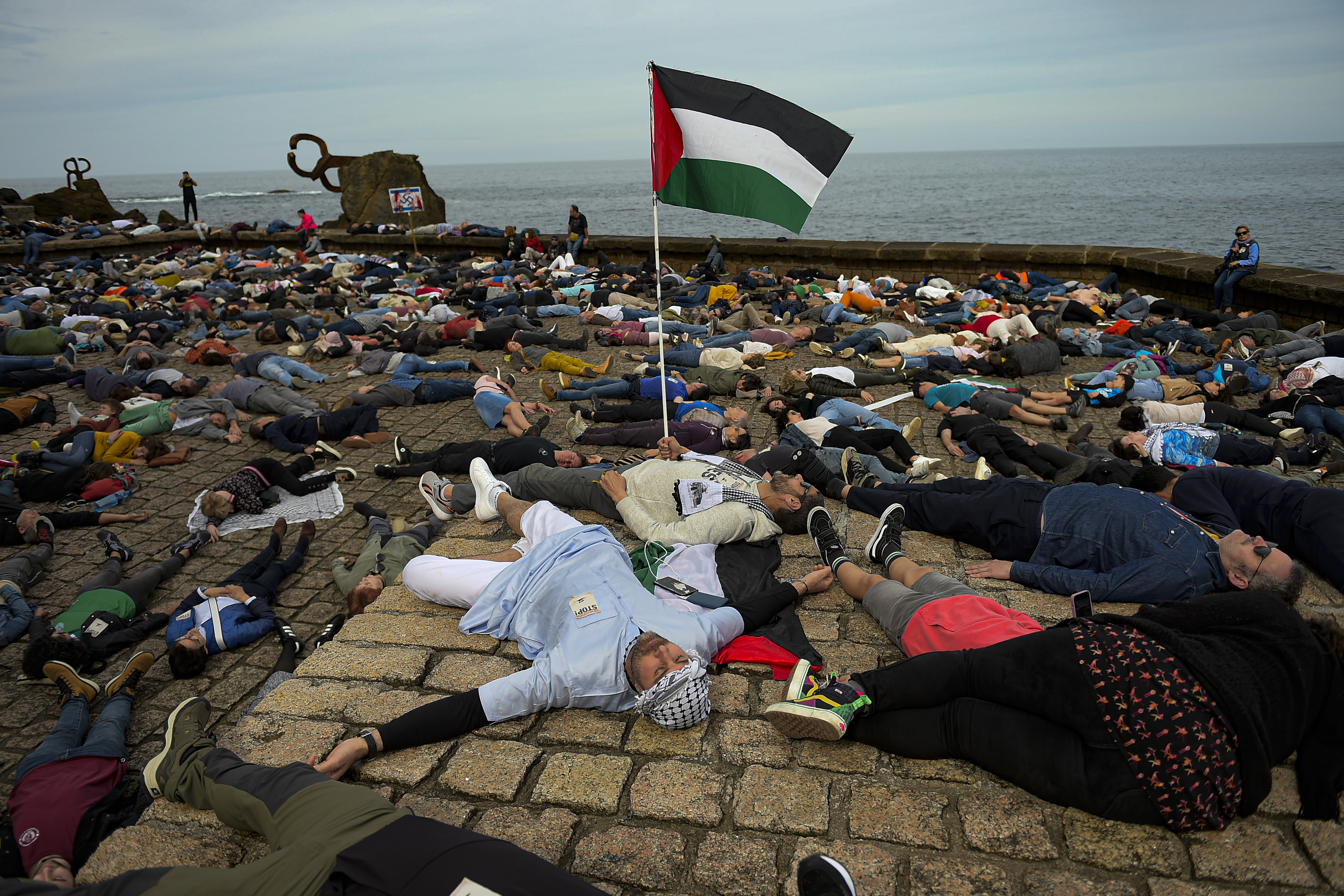 Pro-Palestinian demonstrators lie on the ground as they protest against Israeli attacks on Gaza, in San Sebastian, northern Spain. Photo / AP