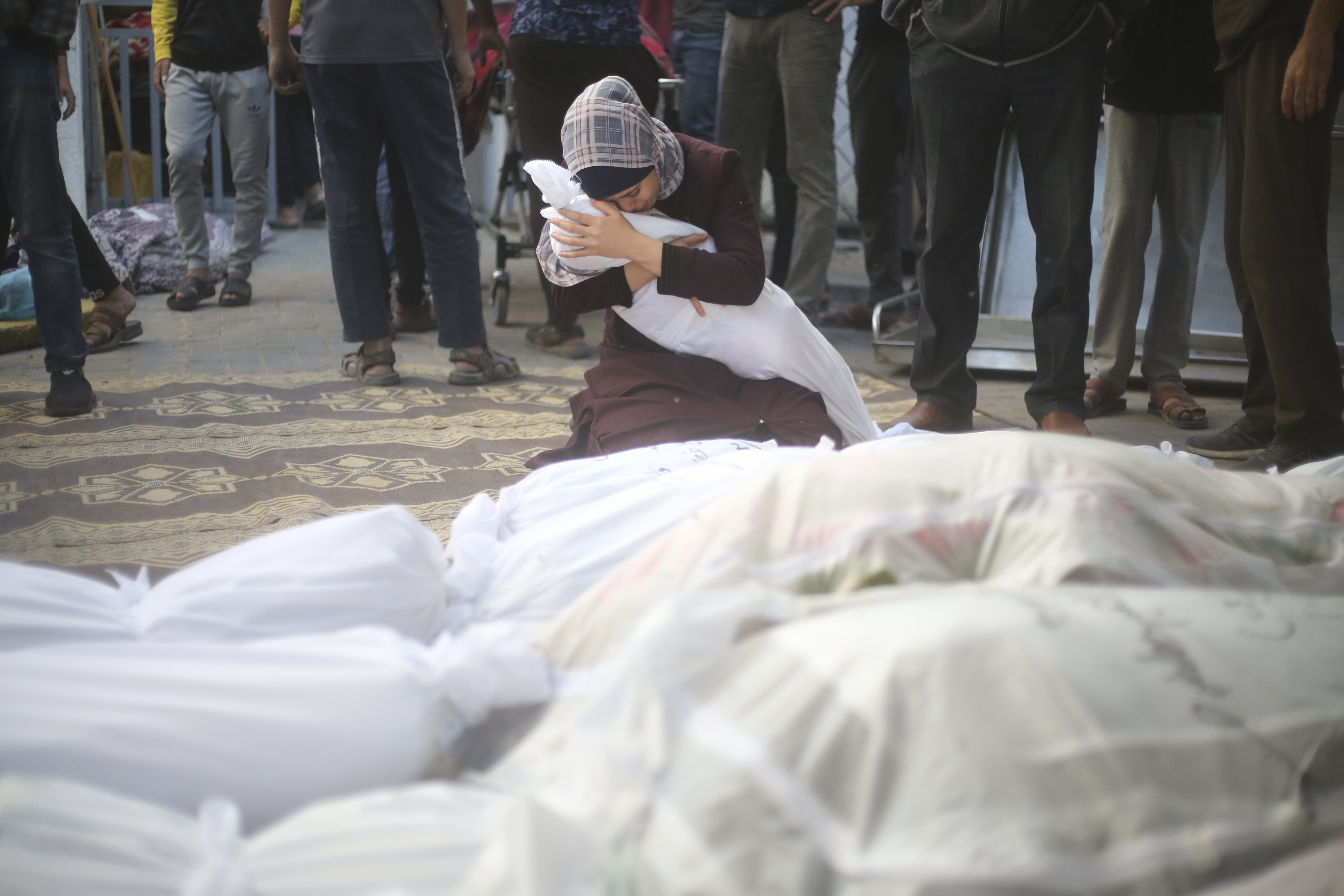 A Palestinian woman holds her cousin killed in the Israeli bombardment of the Gaza Strip in Rafah on Saturday. Photo / AP