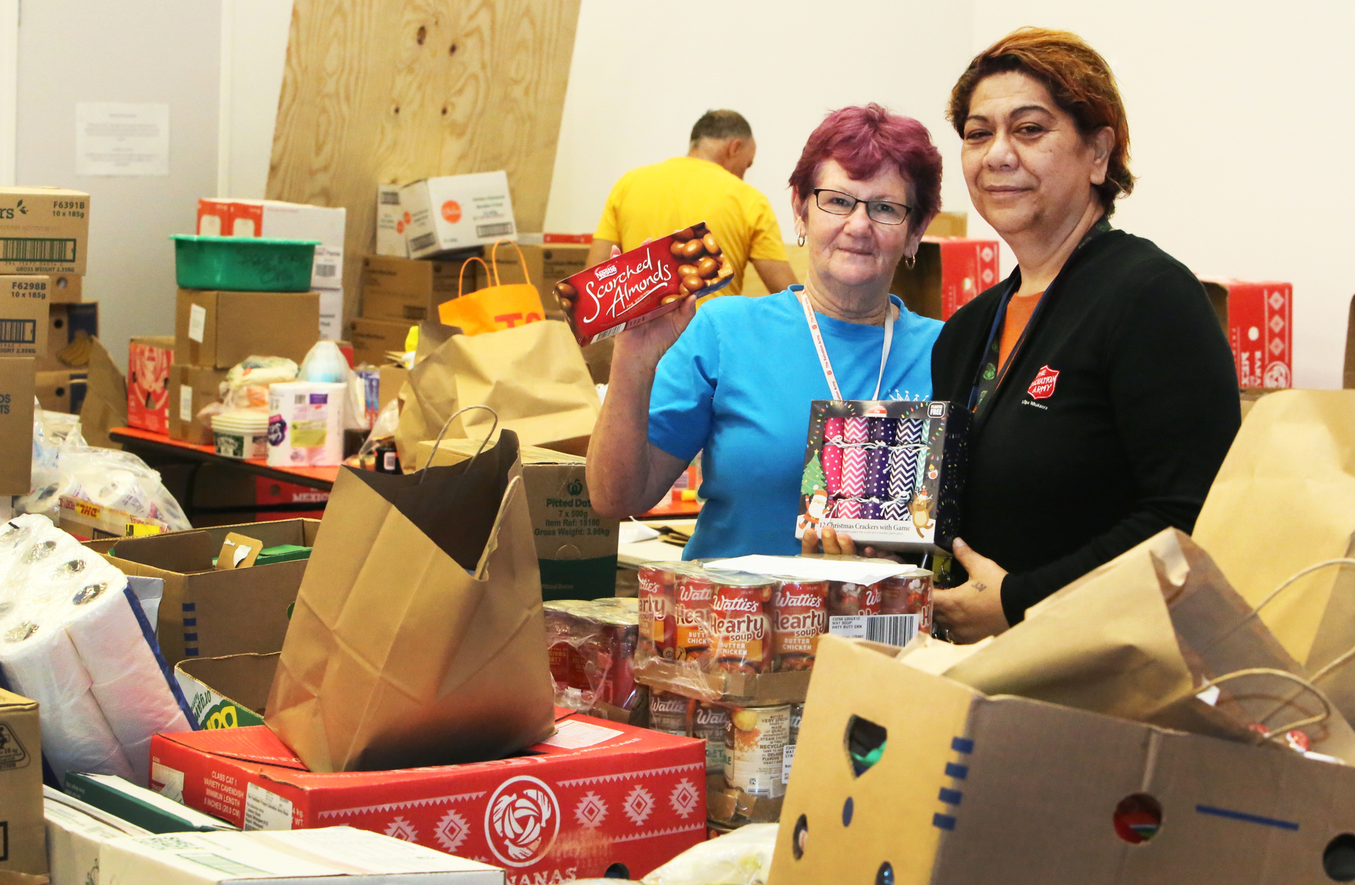Andrea Paul, left, and Verrell Bryson of the Salvation Army in Whangārei prepare food hampers for families in need this Christmas.
Photo / Tania Whyte
Photo / Tania Whyte