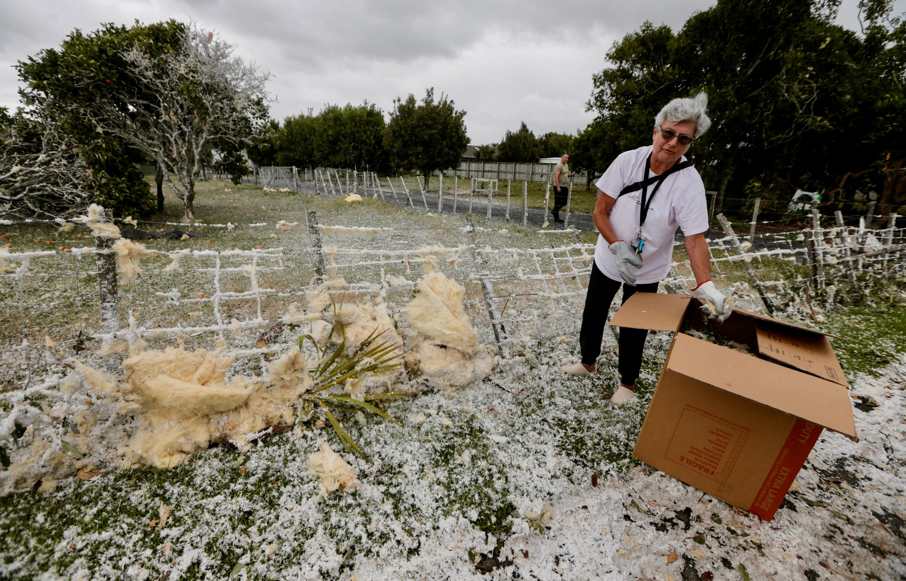 Residents clean up after a tornado swept through Mangawhai in the early hours of Sunday morning. Photo / Alex Burton 