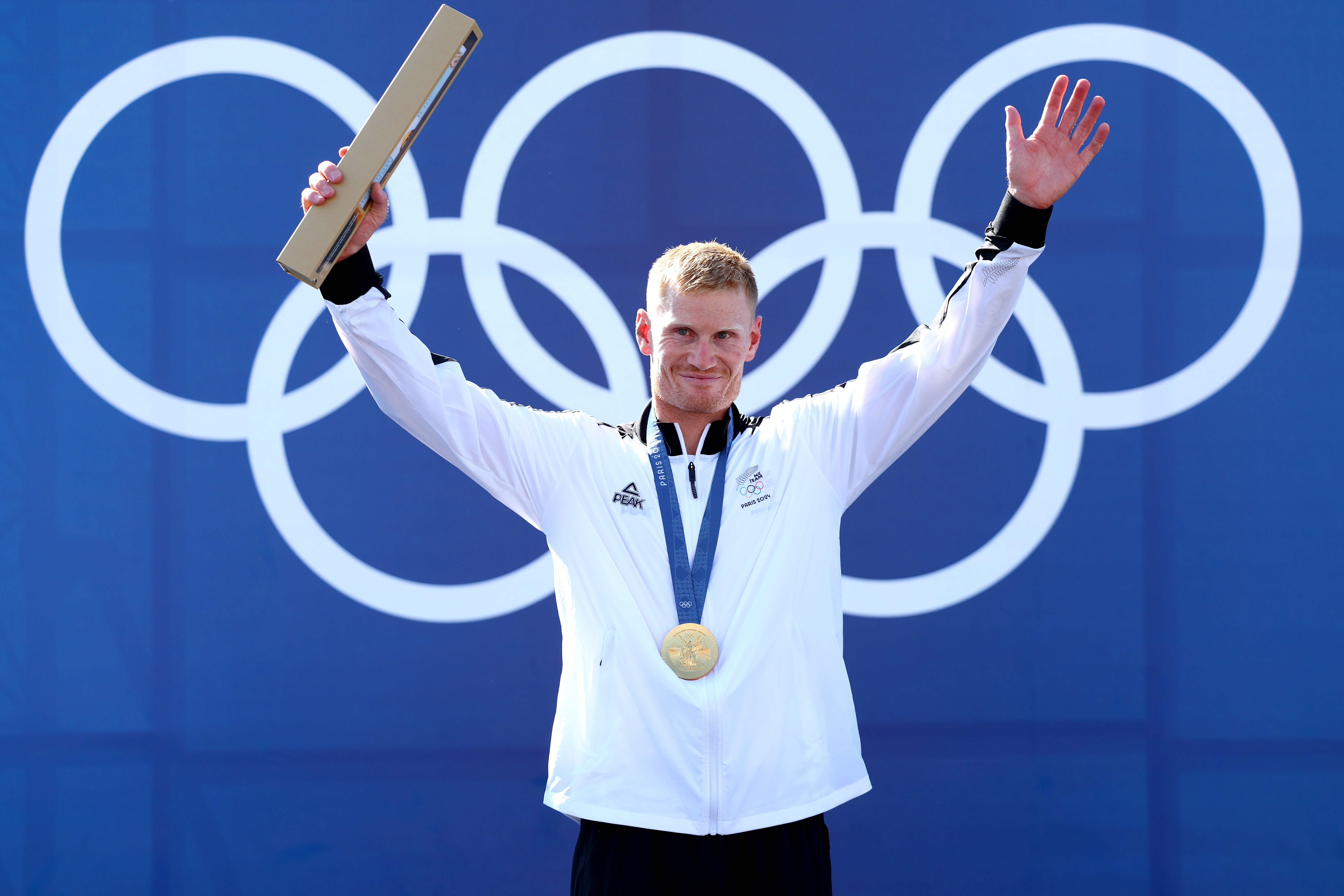 Finn Butcher celebrates with his gold medal in the men's canoe slalom cross at the Paris Olympics. Photo / Getty
