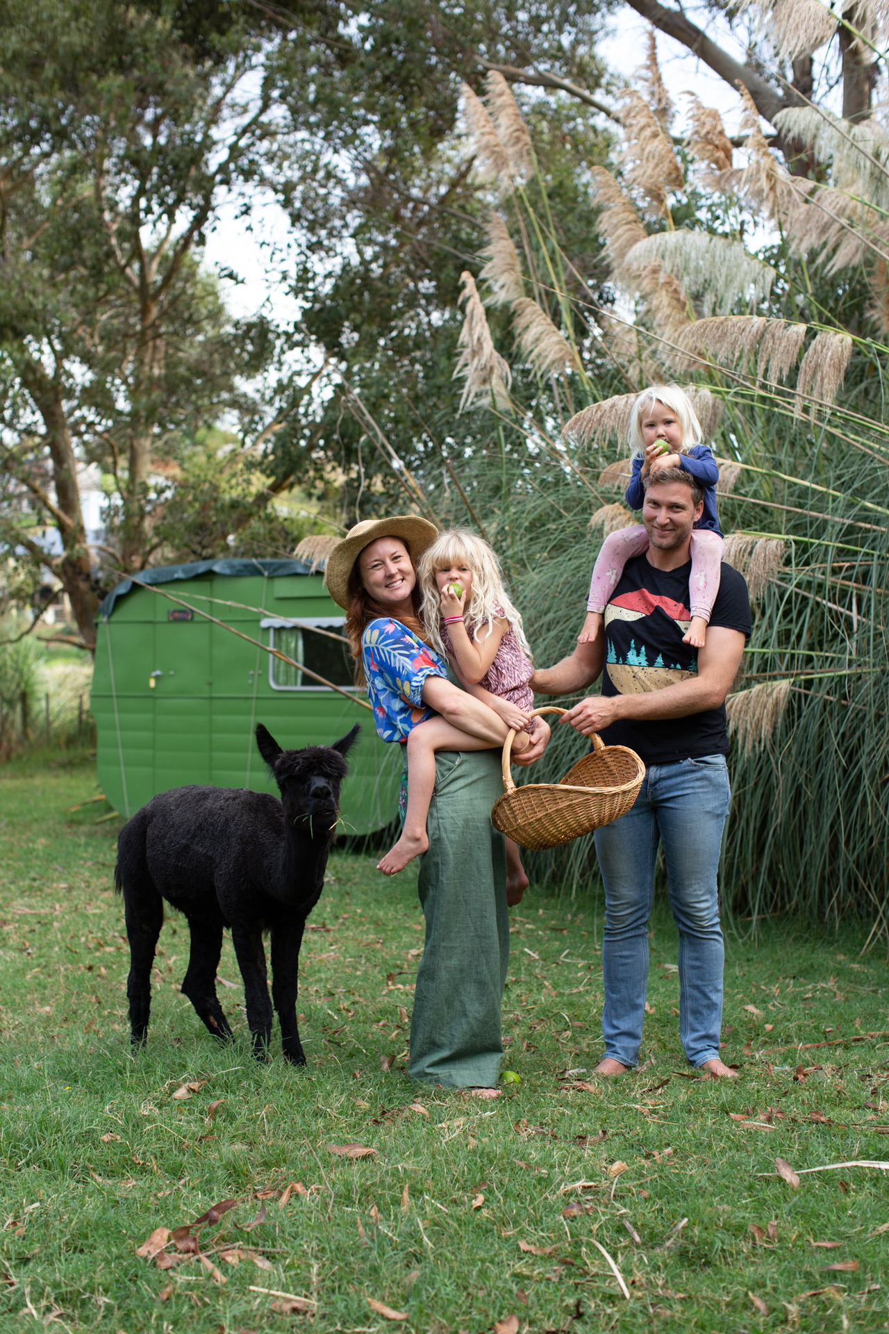 Evans with partner Sam McGlennon, a sustainability consultant, and their daughters Indi and Amalia with one of their alpacas, named Jacinda after being born during lockdown. Photo / Lottie Heldey