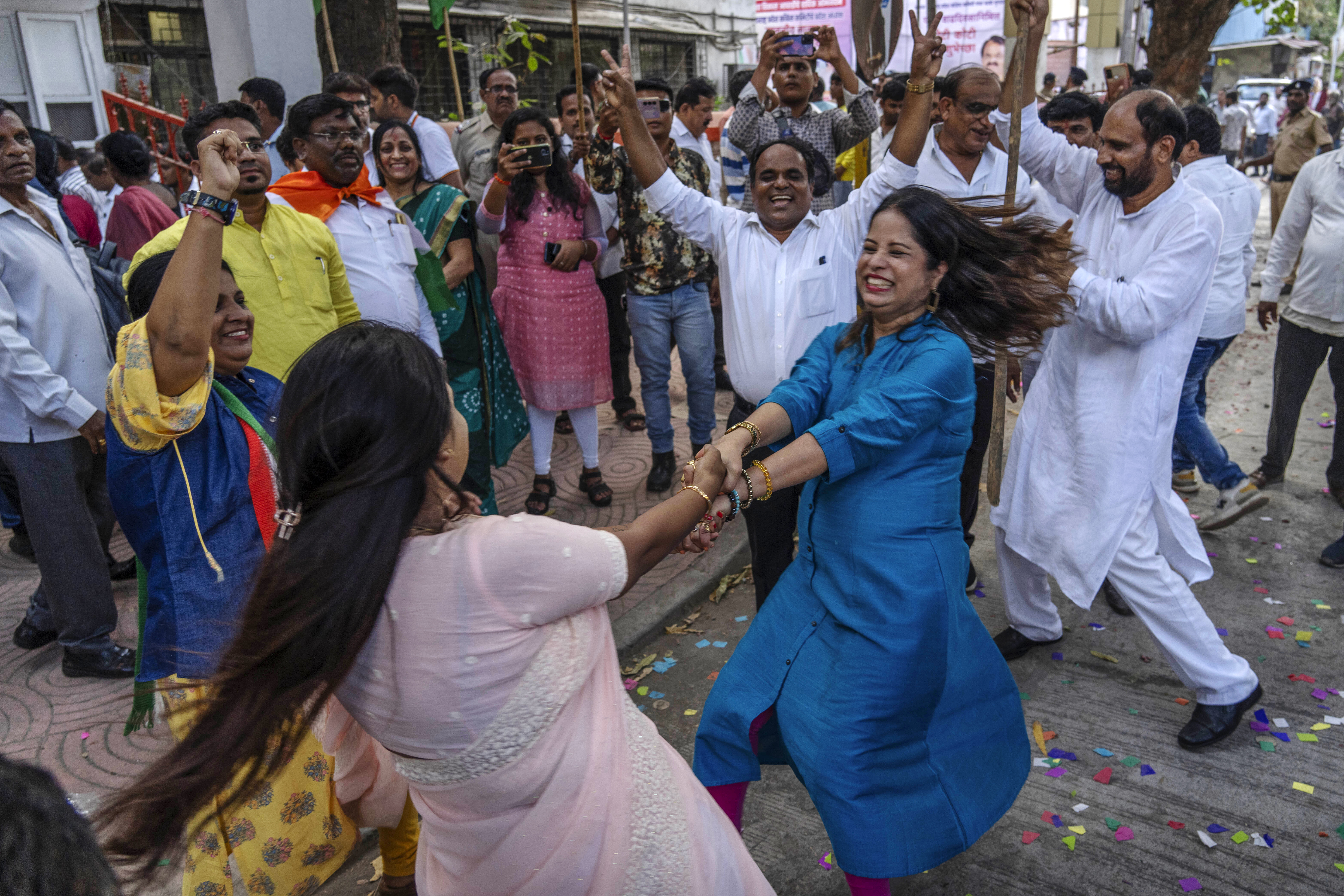 Supporters of India's Congress party dance as they celebrate the party's lead during the counting of votes in India's national election in Mumbai, India. Photo / AP