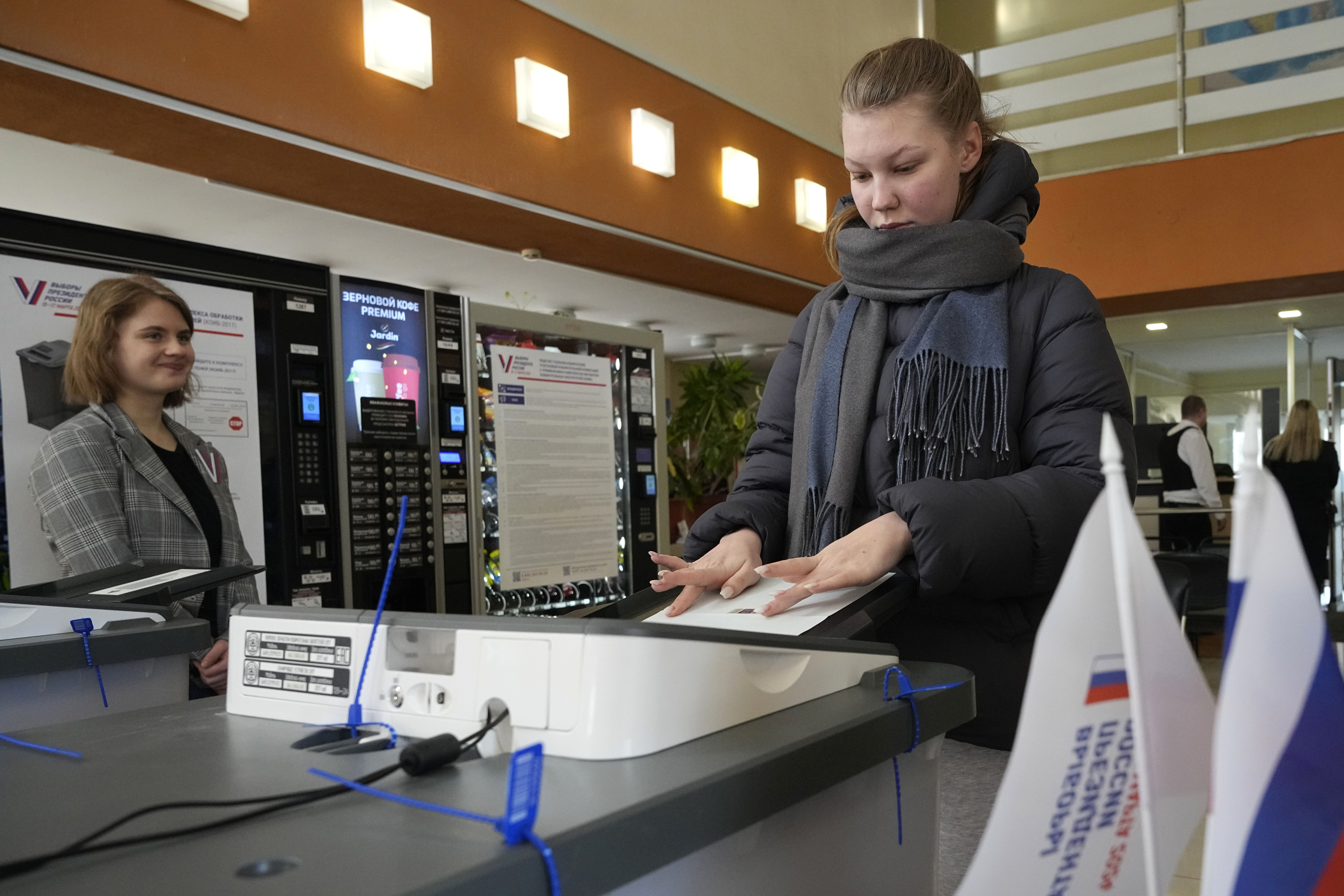 A woman casts a ballot at a pooling station during a presidential election in St. Petersburg, Russia. Photo / AP