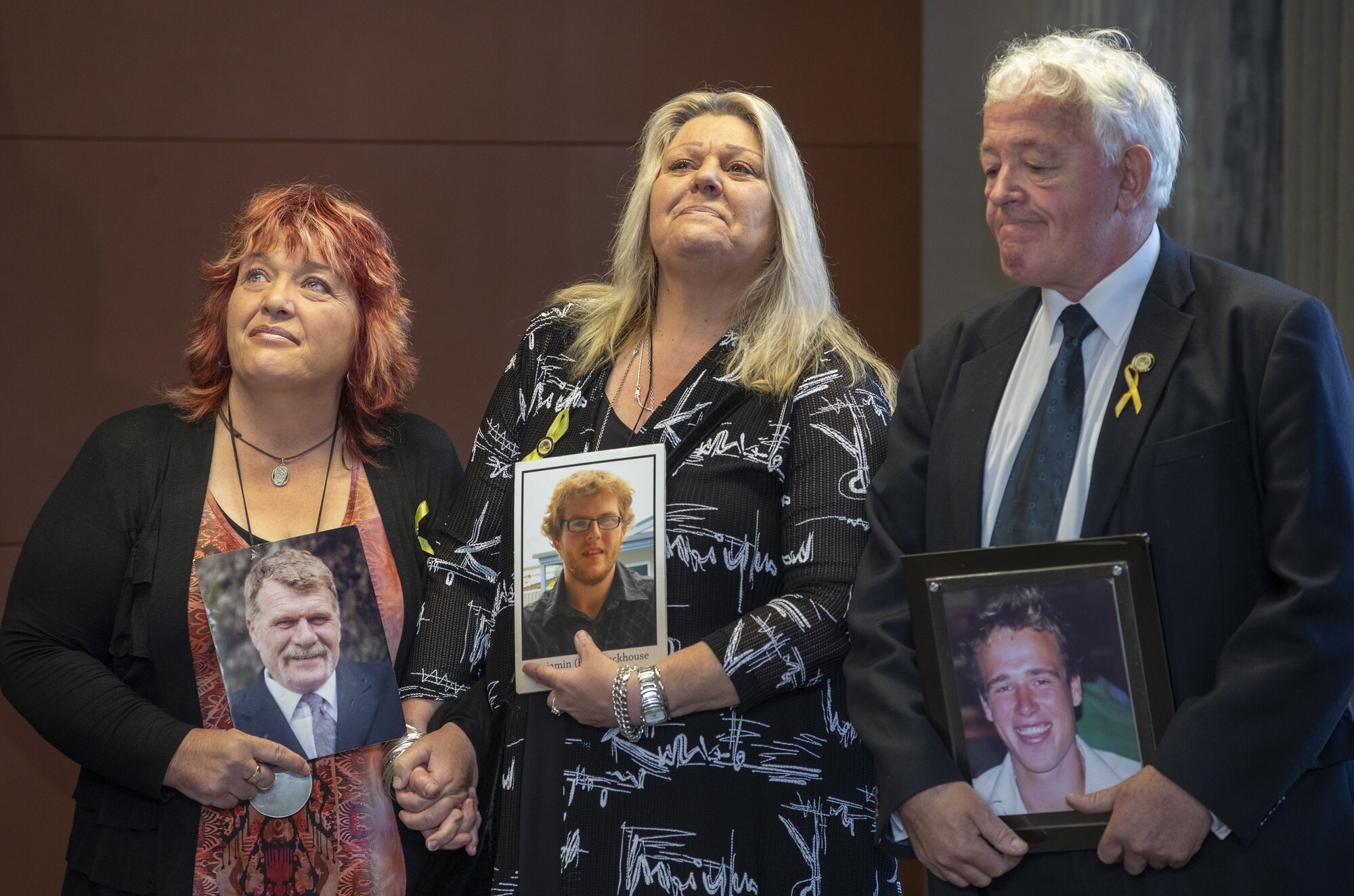Pike River Mine family members Anna Osborne (left), Sonya Rockhouse and Bernie Monk have spoken against changes to health and safety laws. They are pictured here in 2018 holding photographs of (from left) Milton Osborne, Ben Rockhouse and Michael Monk. Photo / Mark Mitchell