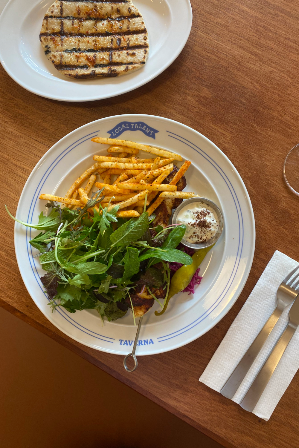 Local Talent Taverna's shawarma spiced organic chicken thigh souvlaki with greek fries, green salad, tzatziki, mixed pickle and grilled pita.