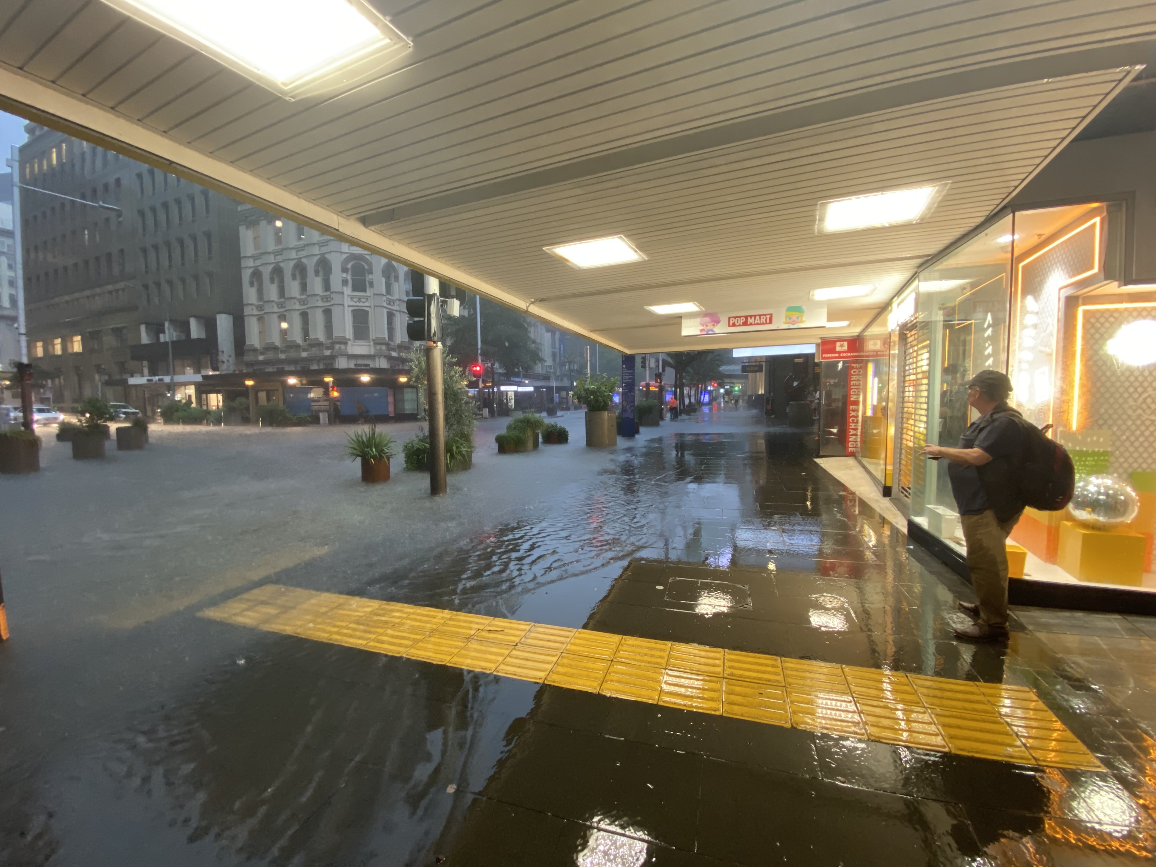 Queen St was turned into a waterway by last night's flooding, with water washing near business entrances. Photo / Cherie Howie
