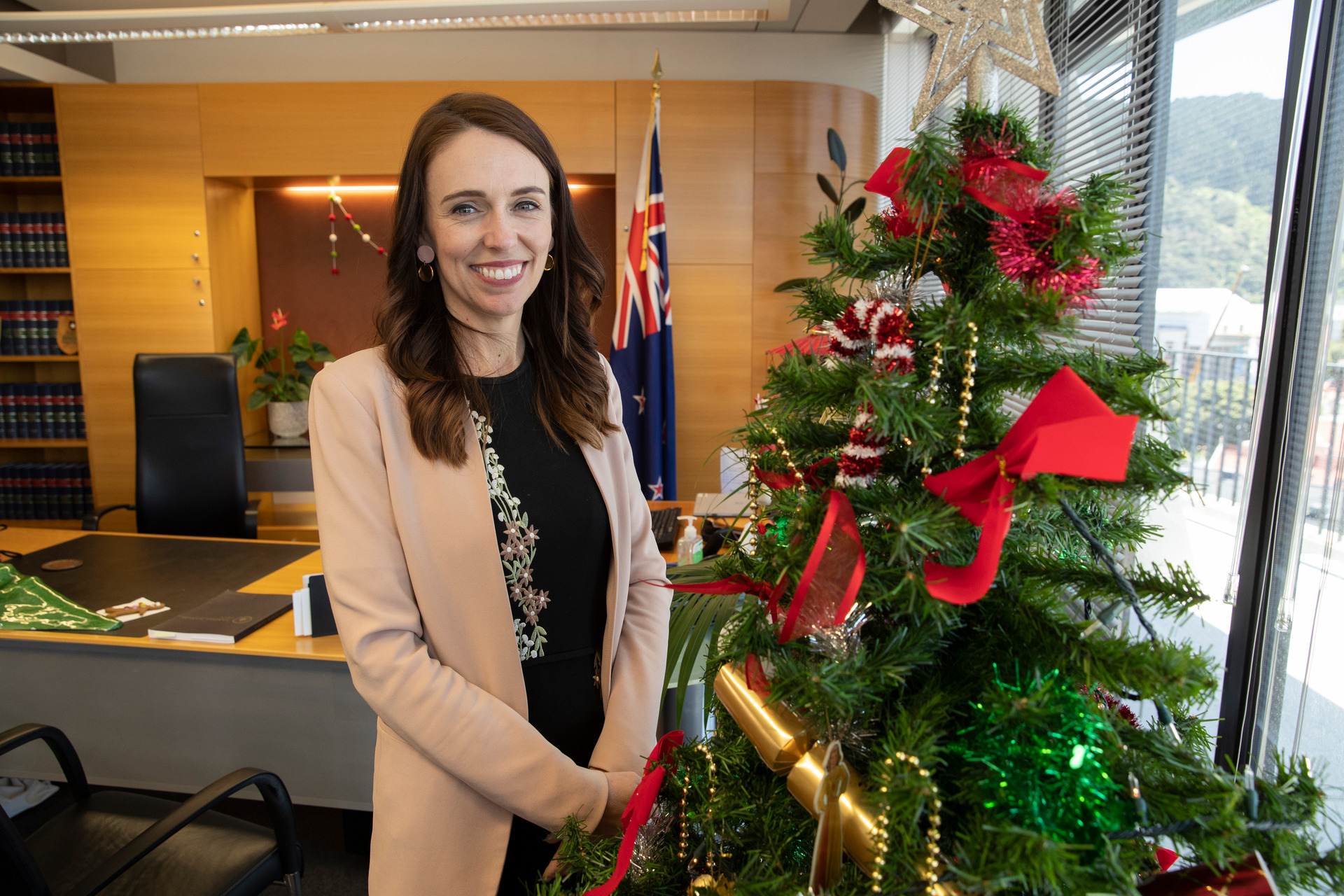 Prime Minister Jacinda Ardern in her Christmas themed office on the Beehive's ninth floor. Photo / Mark Mitchell