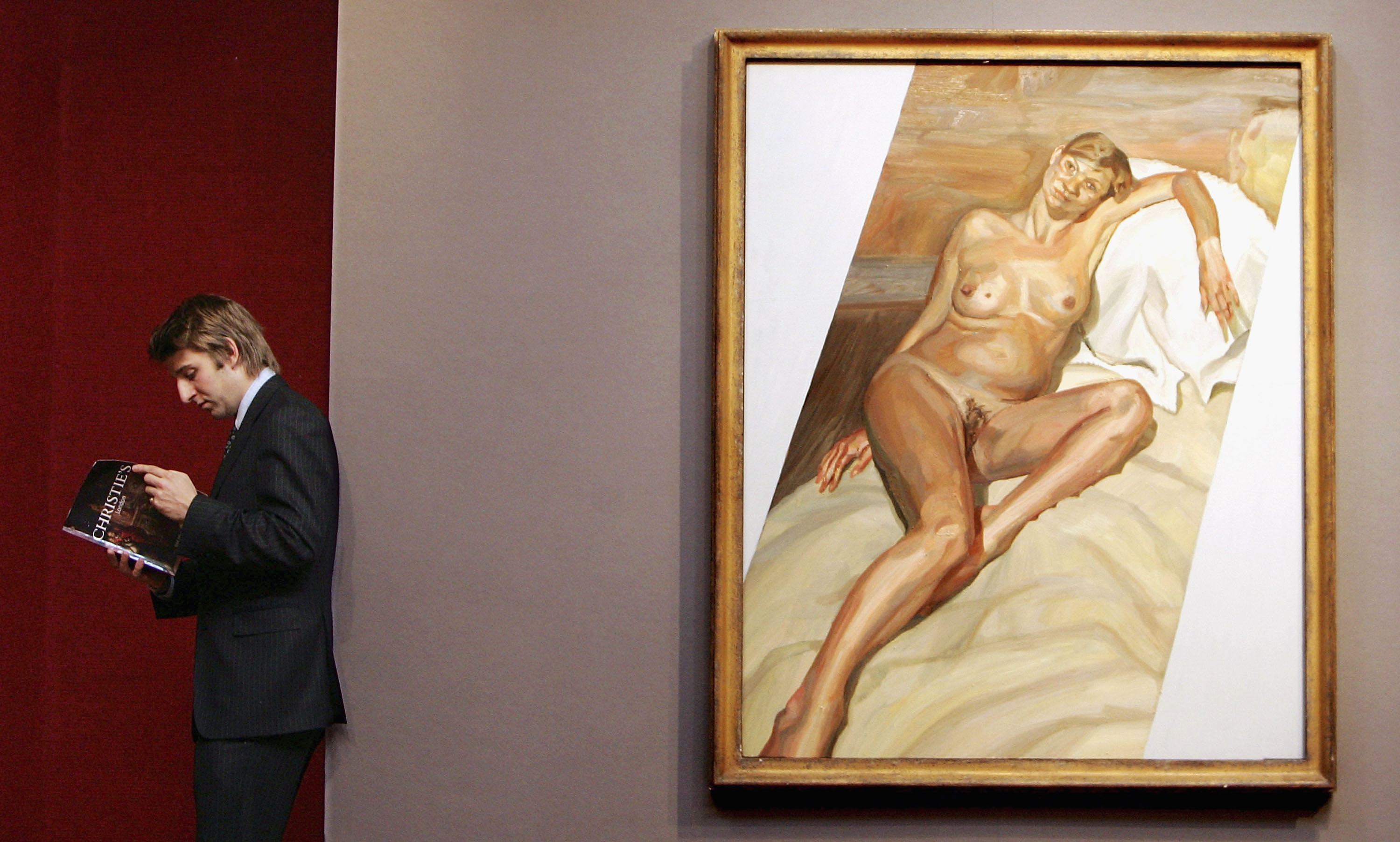Matthew Paton from Christie's auctioneers stands near a nude portrait of British model Kate Moss by Lucian Freud. Photo / Getty Images)