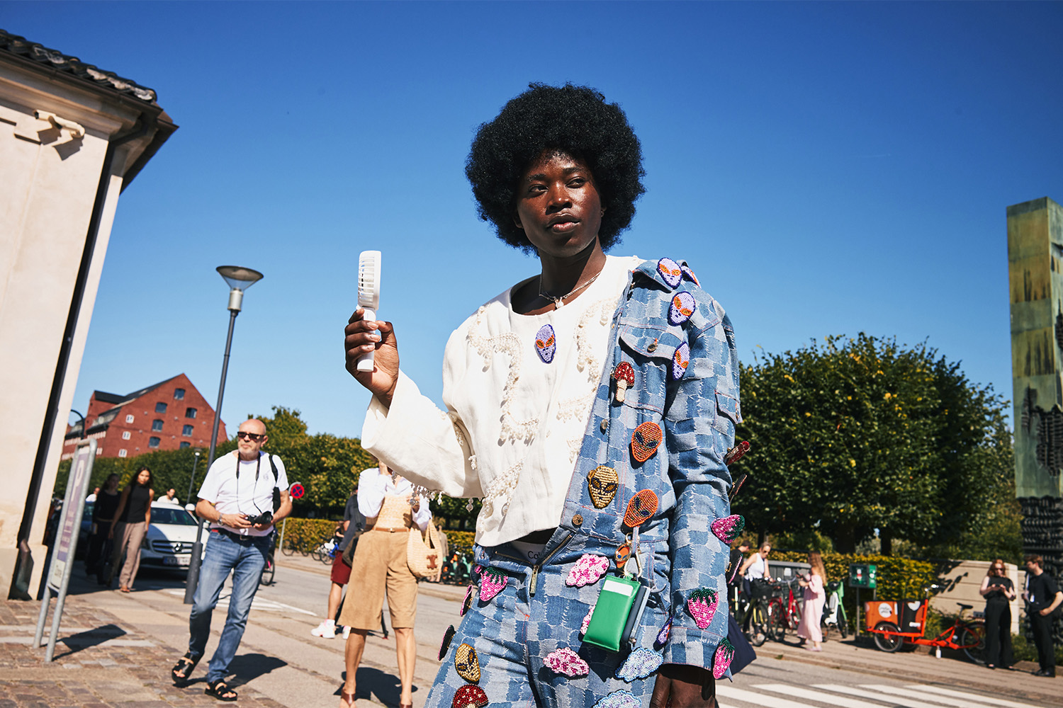 An out-of-this-world ensemble and a hand-held electronic fan. Photo / Simbarashe for The New York Times