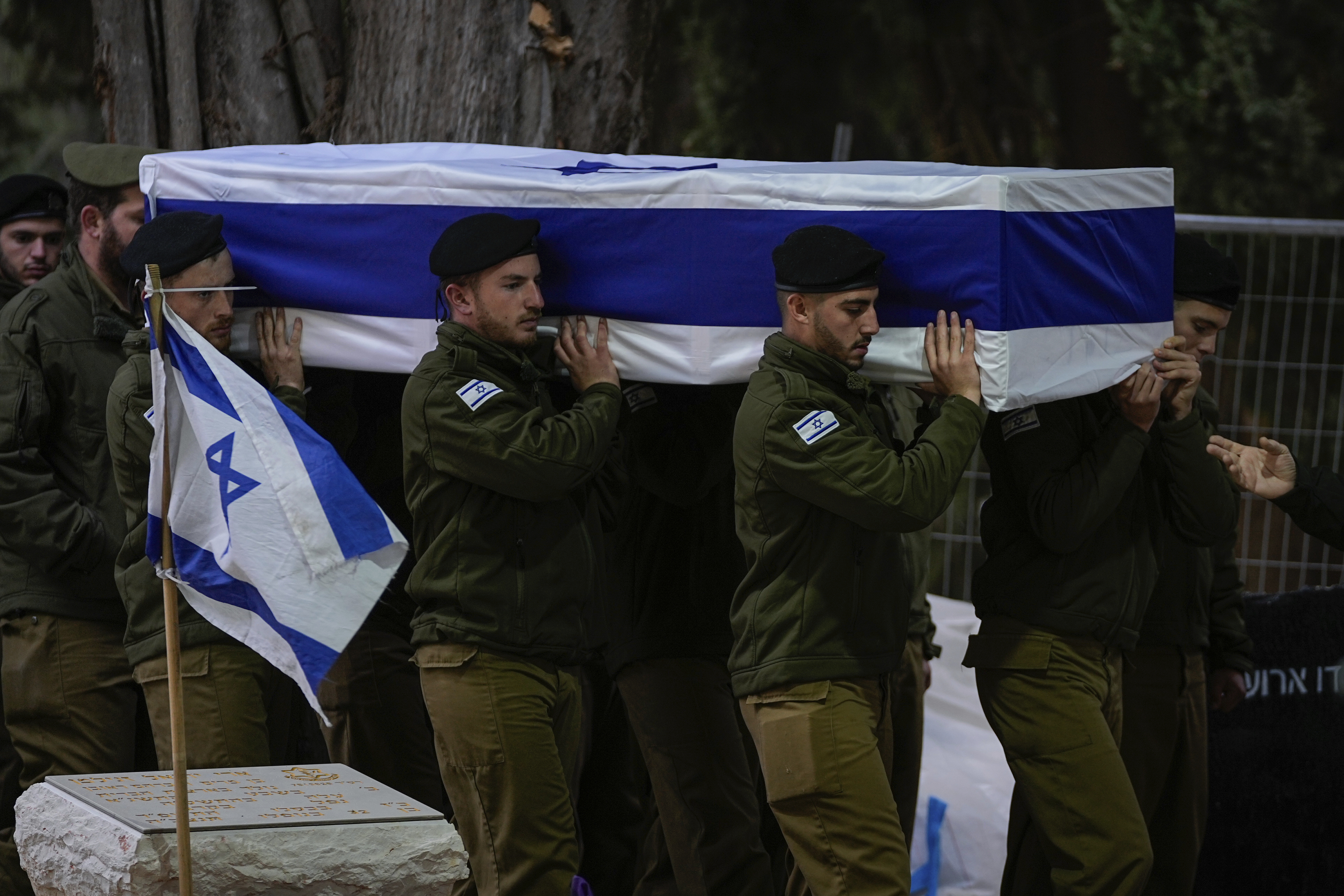 Israeli soldiers carry the flag-draped casket of reservist Hadar Kapeluk during his funeral at Mt Herzl military cemetery in Jerusalem. Photo / AP