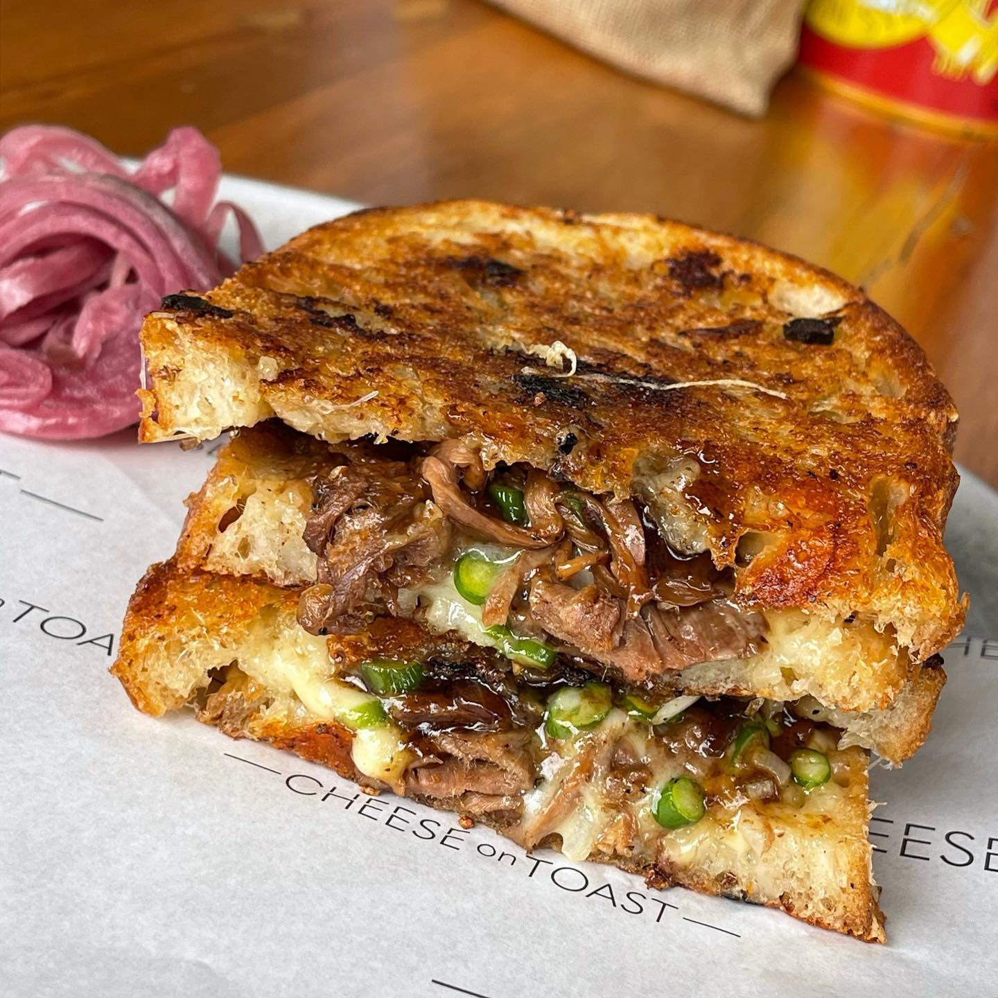 The black pepper beef and cheese, complete with garlic sprouts, white onion and leek, from Cheese on Toast. Photo / @Cheeseontoastnz