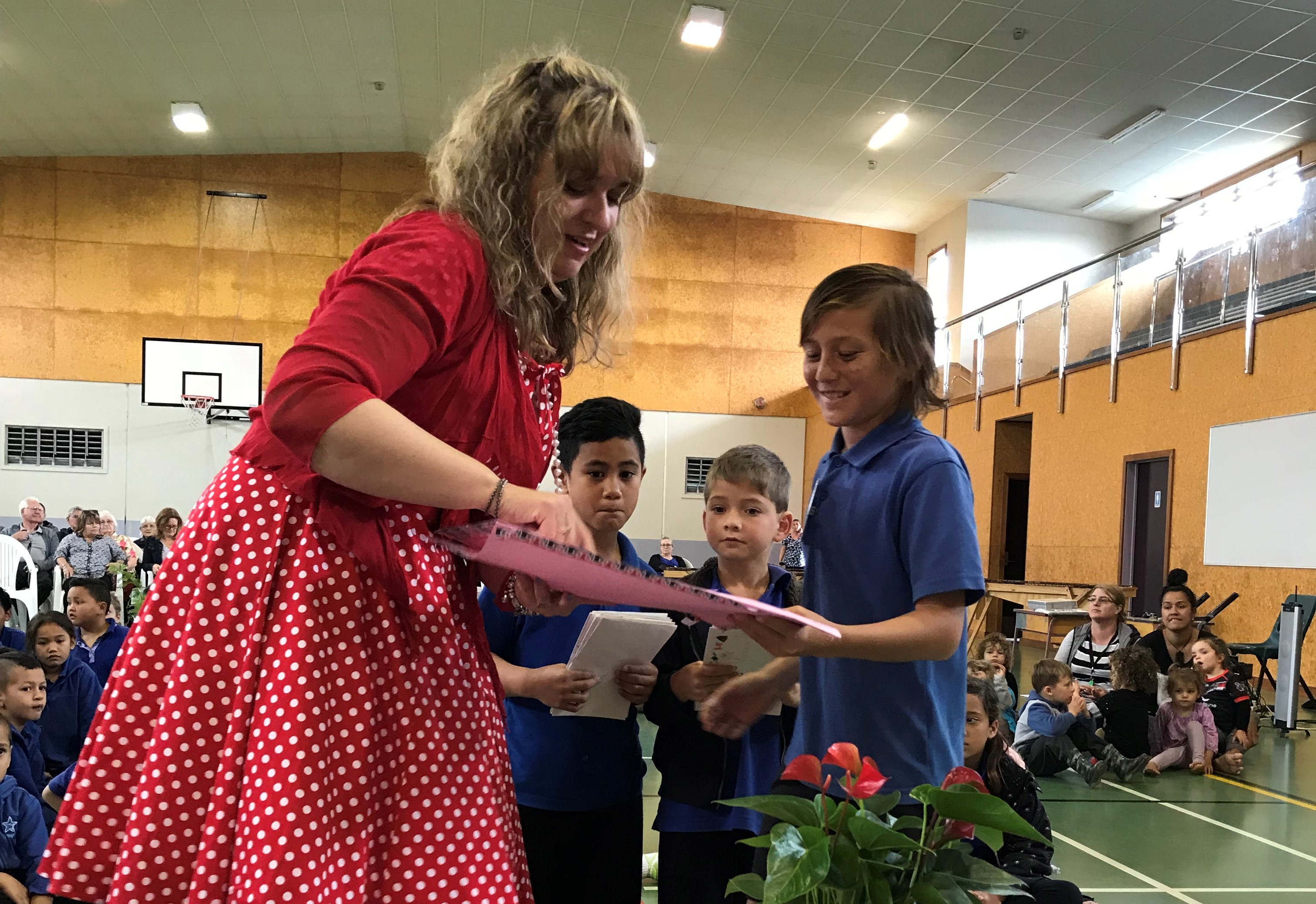 Rayvin Adams-Noda gives Jan Tinetti a handmade card at her farewell from Merivale School. Photo supplied/Dave Merton 