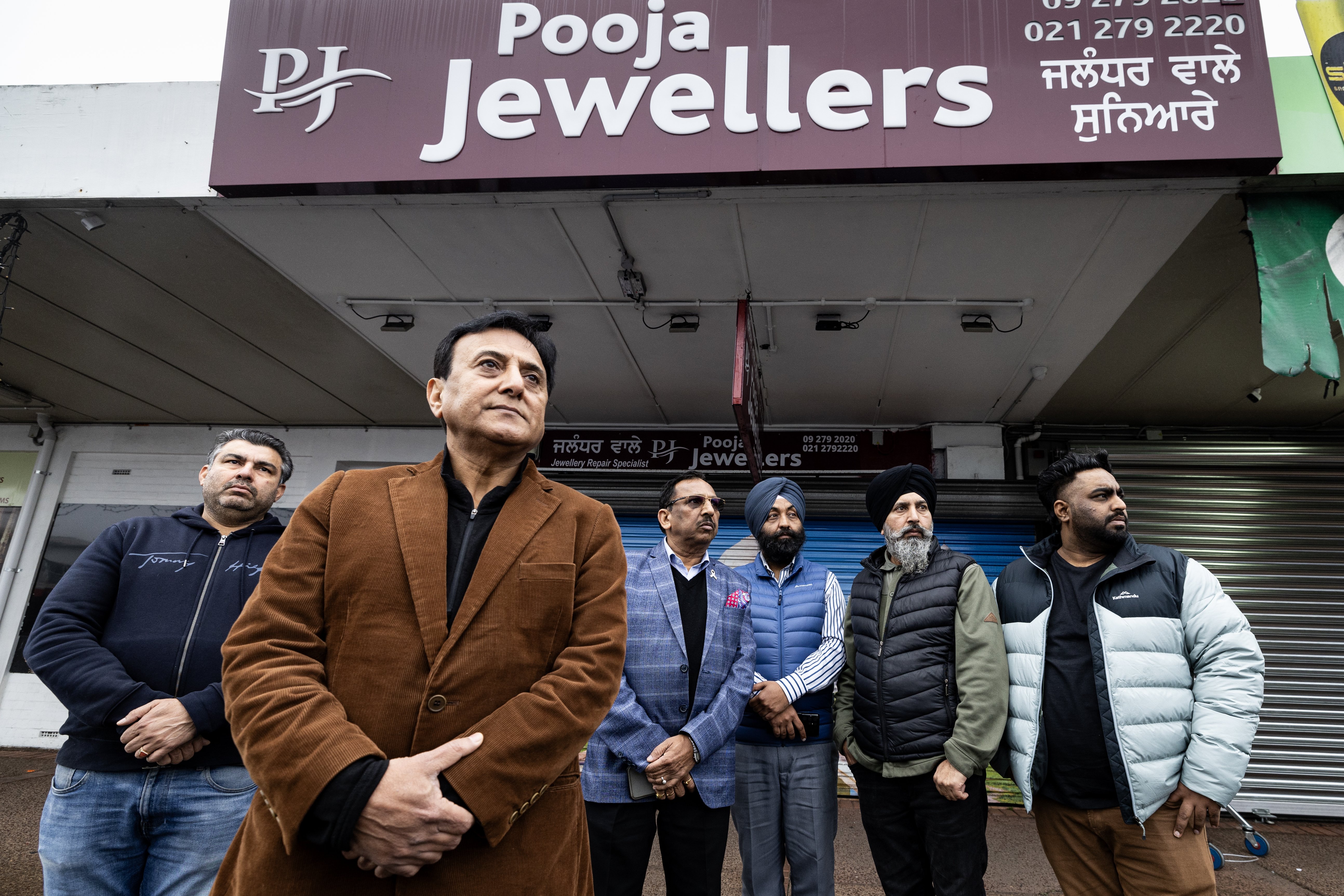 Local business and community leaders, including Sunny Kaushal, gather outside Pooja Jewellers after a violent aggravated robbery at the store. Photo / Jason Oxenham