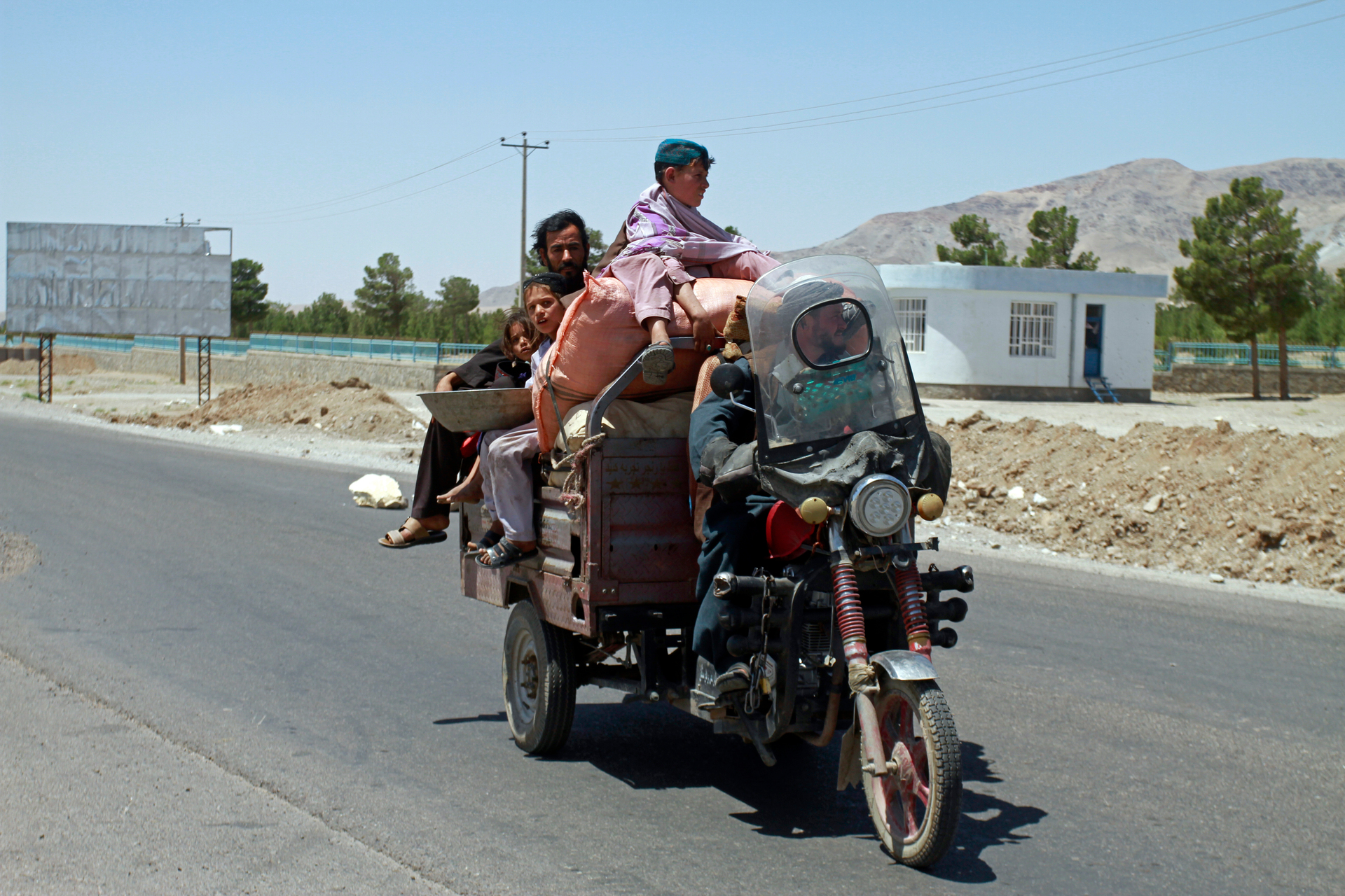 An Afghan family flees fighting as Afghan security personnel took back control of parts of the city of Herat following fighting between Taliban and Afghan security forces. Photo / AP