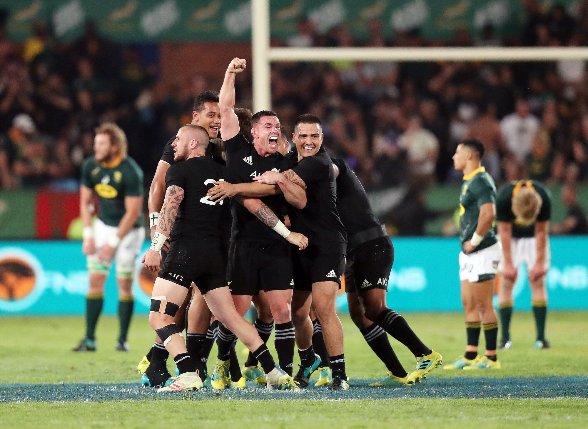 Ryan Crotty celebrates with teammates at the final whistle after the victory in Pretoria. Photo / Photosport