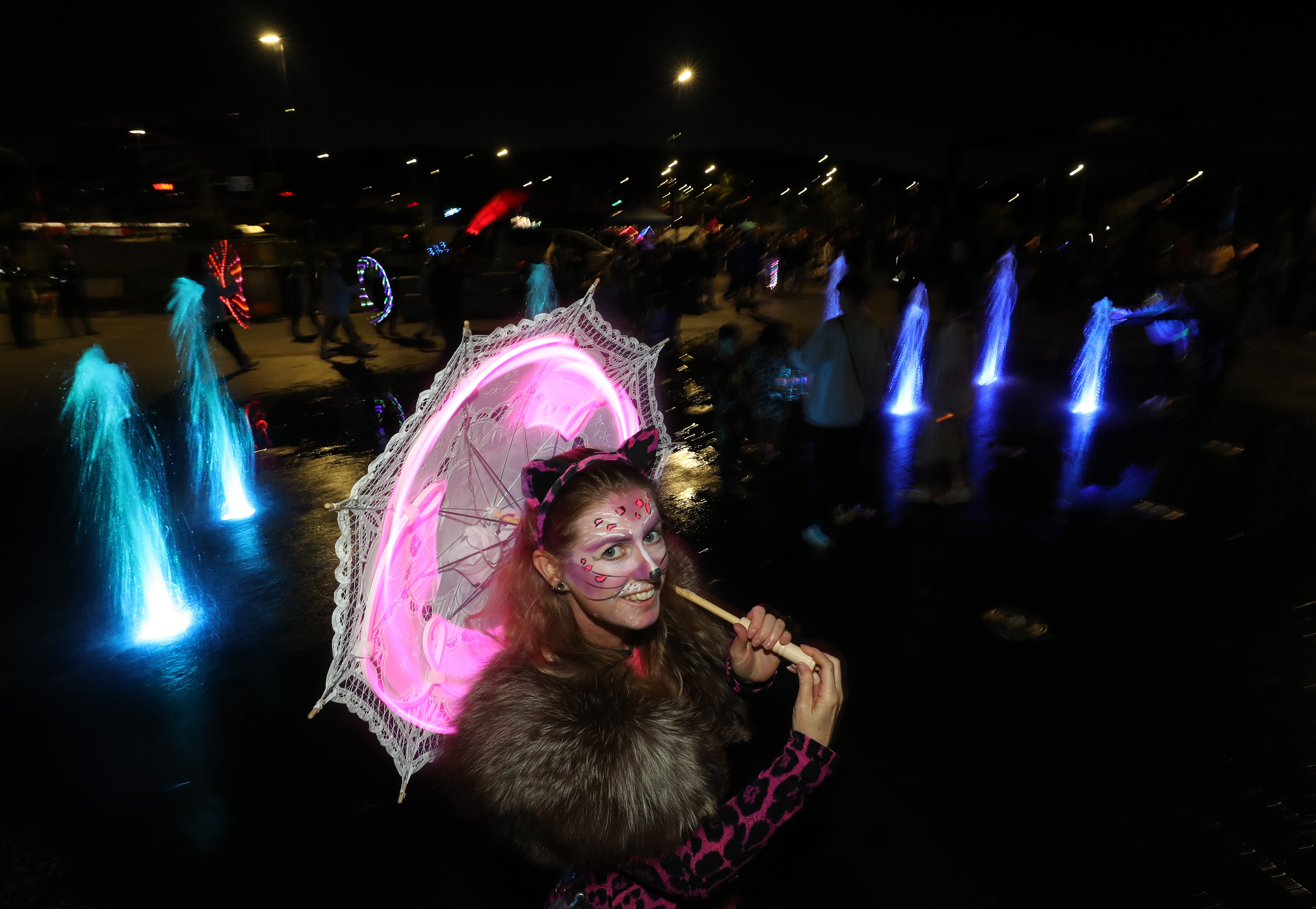 Hannah Mitchell puts on a purrfect performance at the Light and Lantern Parade with her pink parasol. Photo / Michael Cunningham