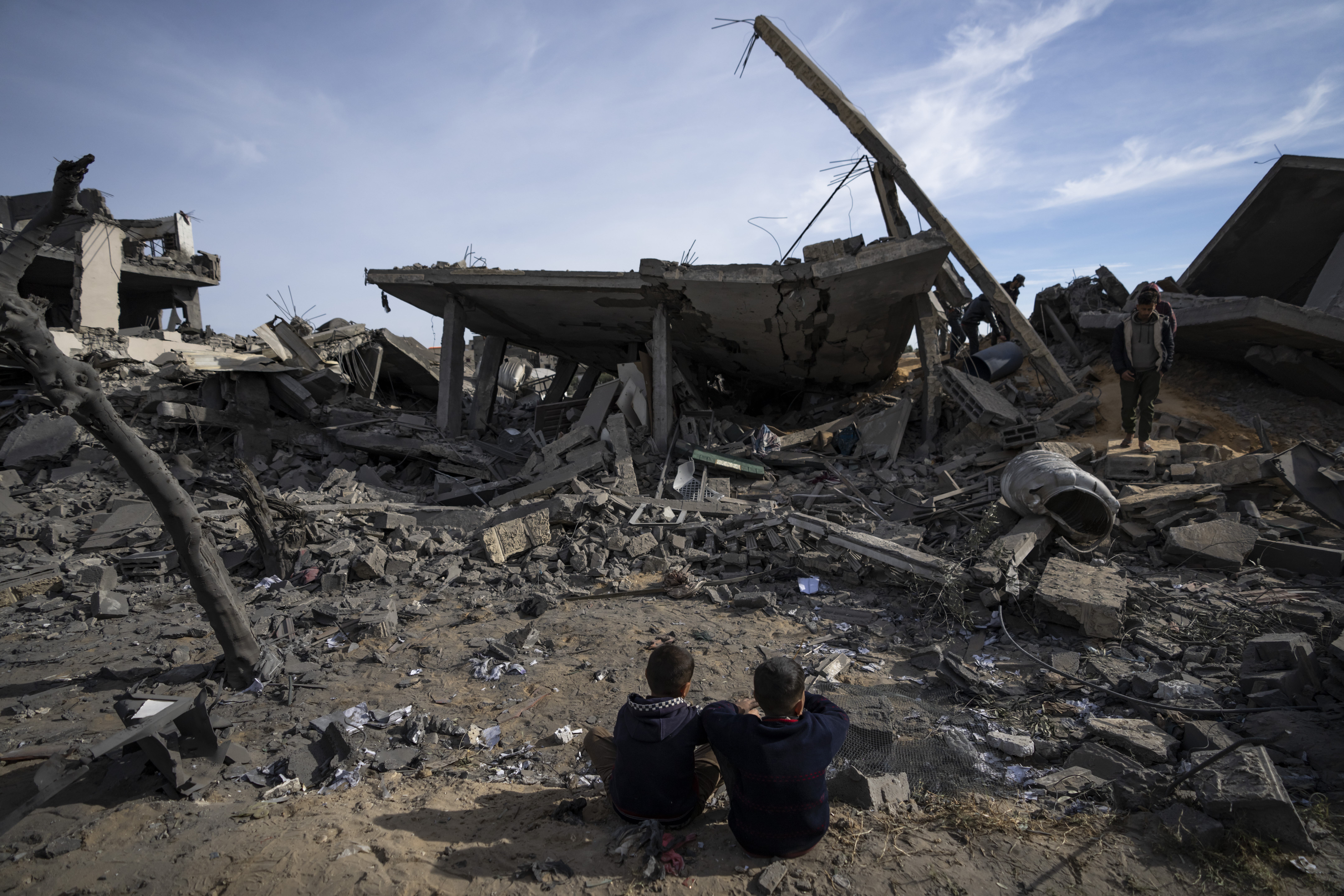 Palestinians search among the rubble of residential buildings where two Israeli hostages were reportedly held before being rescued during an operation by Israeli security forces in Rafah. Photo / AP