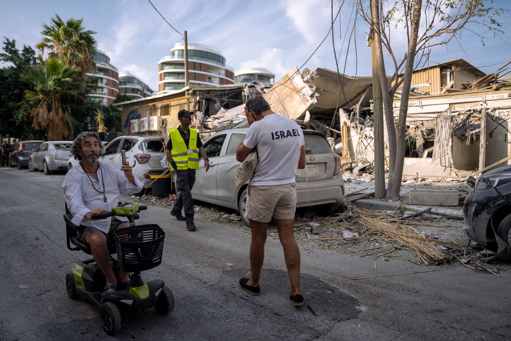 Israelis inspect the rubble of a building a day after it was hit by a rocket fired from the Gaza Strip, in Tel Aviv on October 8. Photo / AP